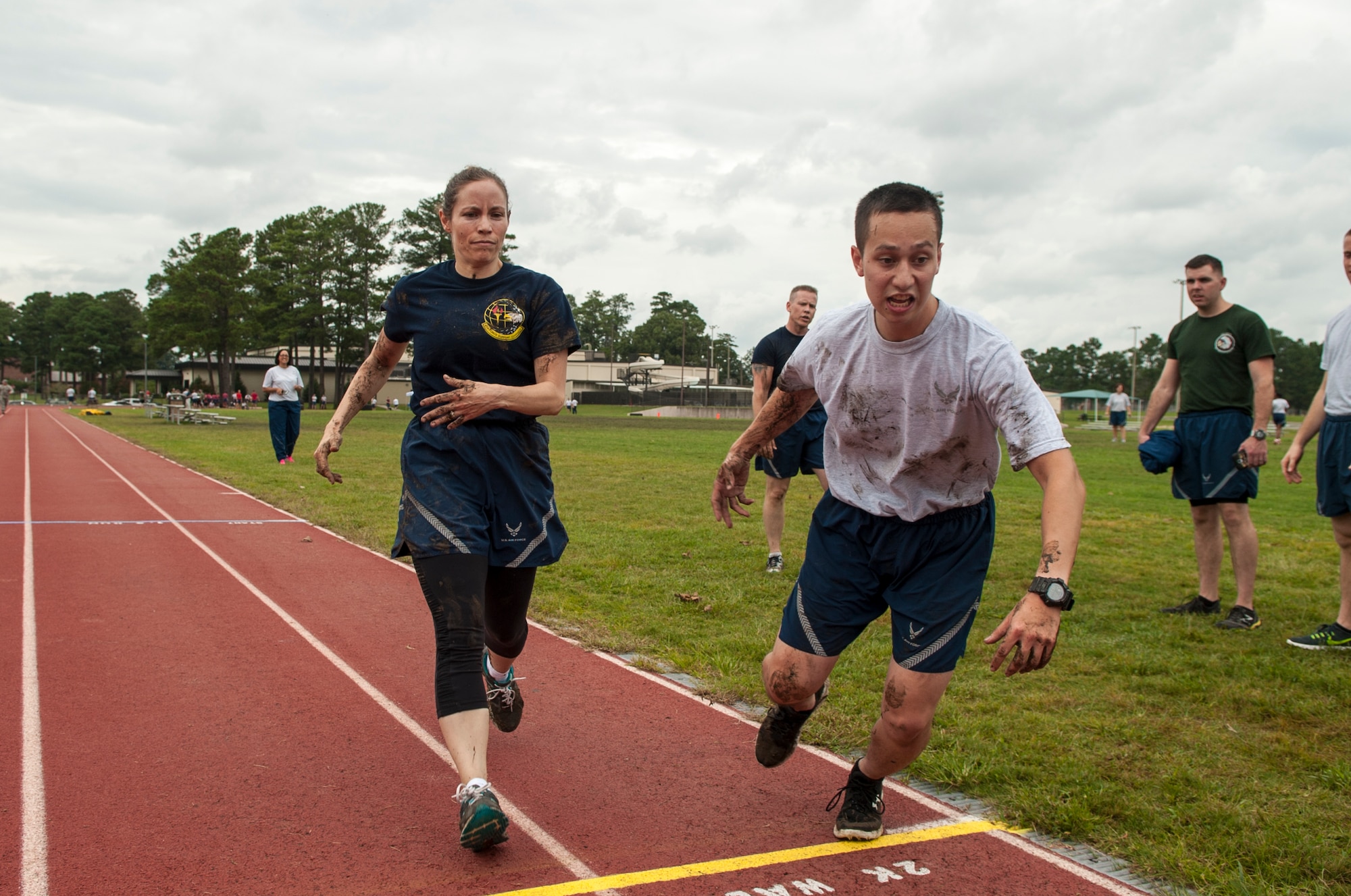 Maj. Coulette Swiggett (left), 4th Force Support Squadron operations officer, tags Airman 1st Class Keisuke Ansara, 4th FSS career development technician, to start running during Comprehensive Airman Fitness Day, Sept. 30, 2015, at Seymour Johnson Air Force Base, North Carolina. As part of the Commander’s Challenge, each team member had to complete one lap around the track to finish the challenge. (U.S. Air Force photo/Airman Shawna L. Keyes)   
