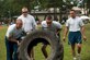 The 4th Security Forces Squadron team flips a tire during Comprehensive Airman Fitness Day, Sept. 30, 2015, at Seymour Johnson Air Force Base, North Carolina. The Commander’s Challenge rallied teams of four that included the squadron’s or group’s commander, chief, first sergeant, and youngest Airman. (U.S. Air Force photo/Airman Shawna L. Keyes)  