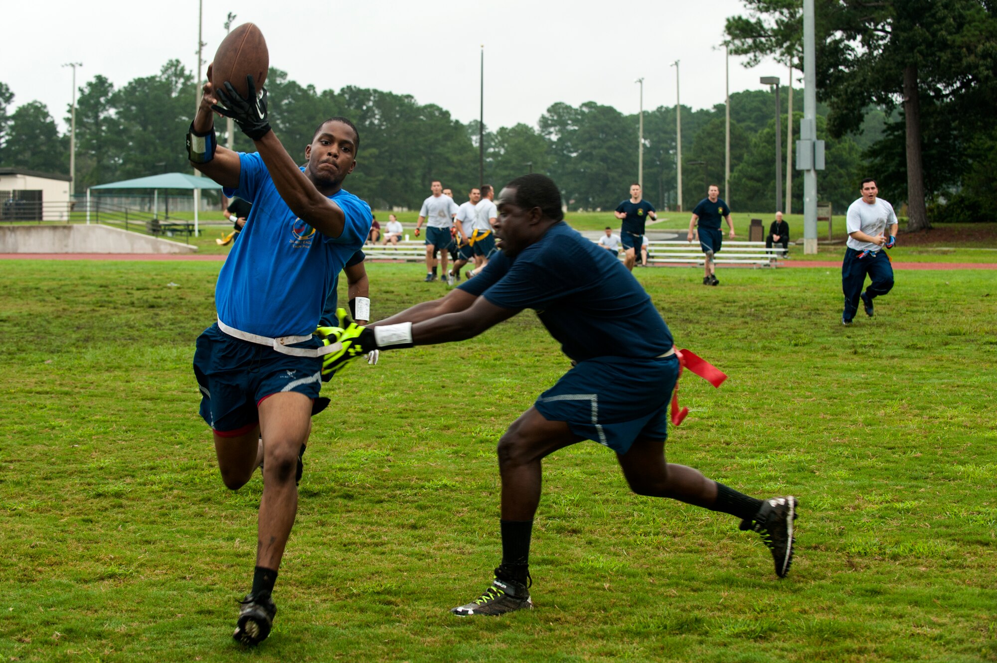 An Airman from the 4th Aircraft Maintenance Squadron catches a football during Comprehensive Airman Fitness Day, Sept. 30, 2015, at Seymour Johnson Air Force Base, North Carolina. Teams competed in several elimination rounds to determine the overall winner for flag football. (U.S. Air Force photo/Airman Shawna L. Keyes)