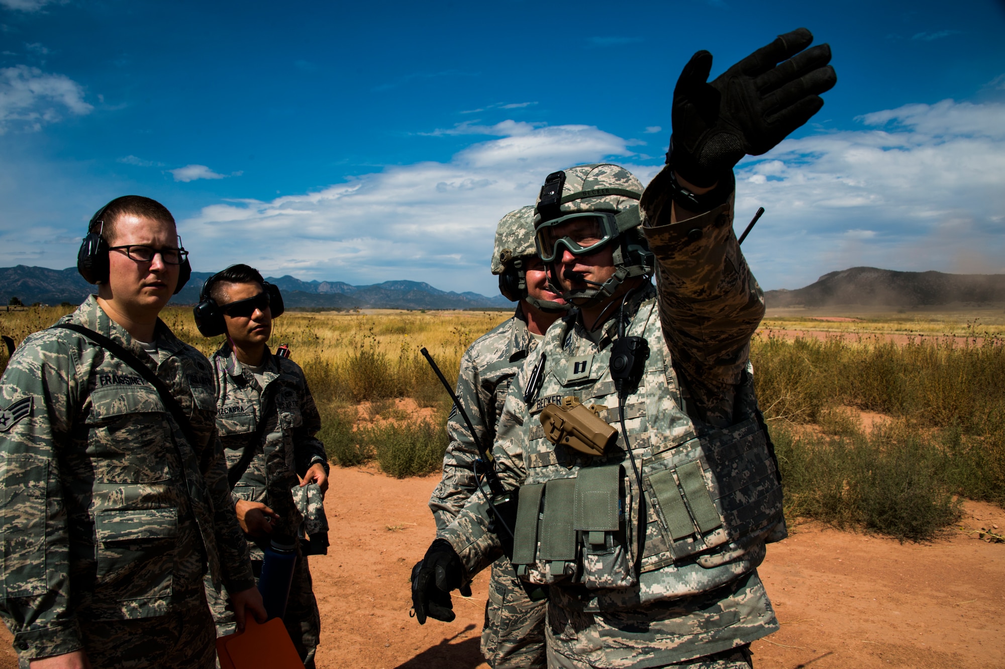 Exercise Cerberus Strike participants discuss ramp coordination after a C-130 landed at Red Devil, Colo., on September 14, 2015 Approximately 150 Airmen from the 821st Contingency Response Group at Travis Air Force Base, Calif., participated in a first-of-its-kind Joint contingency response exercise from Sept. 8-19 at five locations (Southern California Logistics Airfield, Calif., Freedom Landing Zone, Calif., Gunnison Region Airfield, Colo., Red Devil Landing Zone, Colo., Peterson Air Force Base, Colo., and Fort Carson, Colo.). During the training, 821st CRG Airmen supported more than 275 Soldiers from Fort Carson, Colo., during air drop missions, helicopter training, coordinated Apache air support, and personnel and equipment airlift training. The Contingency Response (CR) training was constructed to primarily develop unique CR-oriented training objectives to improve down range effectiveness in preparation for real-world responses. (U.S. Air Force Photos by Tech. Sgt. Matthew Hannen)