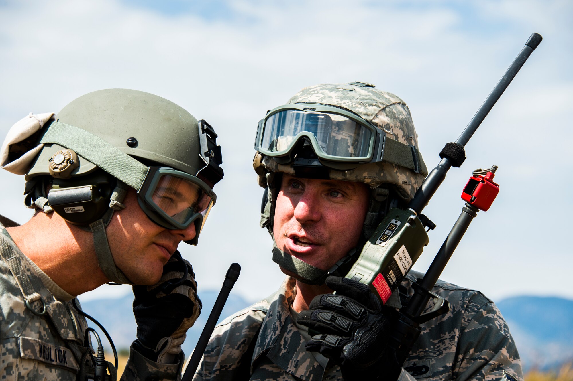 Lt. Col. Jeffery Krulick, Director of Operations discusses ramp coordination plans with Tech. Sgt Michael Eggelston, ramp coordination operator, both from the 821st Contingency Response Squadron at Travis Air Force Base, Calif., during Exercise Cerberus Strike at Red Devil landing zone, Colo., on September 14, 2015. Approximately 150 Airmen from the 821st Contingency Response Group at Travis Air Force Base, Calif., participated in a first-of-its-kind Joint contingency response exercise from Sept. 8-19 at five locations (Southern California Logistics Airfield, Calif., Freedom Landing Zone, Calif., Gunnison Region Airfield, Colo., Red Devil Landing Zone, Colo., Peterson Air Force Base, Colo., and Fort Carson, Colo.). During the training, 821st CRG Airmen supported more than 275 Soldiers from Fort Carson, Colo., during air drop missions, helicopter training, coordinated Apache air support, and personnel and equipment airlift training. The Contingency Response (CR) training was constructed to primarily develop unique CR-oriented training objectives to improve down range effectiveness in preparation for real-world responses. (U.S. Air Force Photos by Tech. Sgt. Matthew Hannen)