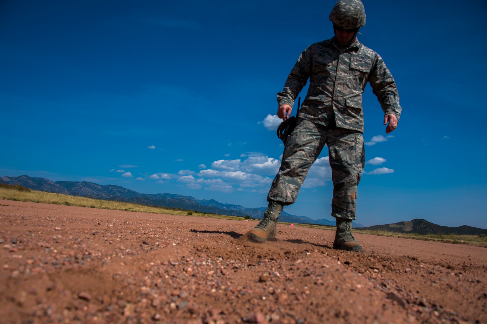 Staff Sgt. William Crew, an air field manager for the 821st Contingency Response Support Squadron from Travis Air Force Base, Calif., fixes holes on Red Devil landing zone (a dirt runway on Fort Carson, Colo.),  prior to C-130 Aircraft landing during Exercise Cerberus Strike, on September 14, 2015. Approximately 150 Airmen from the 821st Contingency Response Group at Travis Air Force Base, Calif., participated in a first-of-its-kind Joint contingency response exercise from Sept. 8-19 at five locations (Southern California Logistics Airfield, Calif., Freedom Landing Zone, Calif., Gunnison Region Airfield, Colo., Red Devil Landing Zone, Colo., Peterson Air Force Base, Colo., and Fort Carson, Colo.). During the training, 821st CRG Airmen supported more than 275 Soldiers from Fort Carson, Colo., during air drop missions, helicopter training, coordinated Apache air support, and personnel and equipment airlift training. The Contingency Response (CR) training was constructed to primarily develop unique CR-oriented training objectives to improve down range effectiveness in preparation for real-world responses. (U.S. Air Force Photos by Tech. Sgt. Matthew Hannen)
