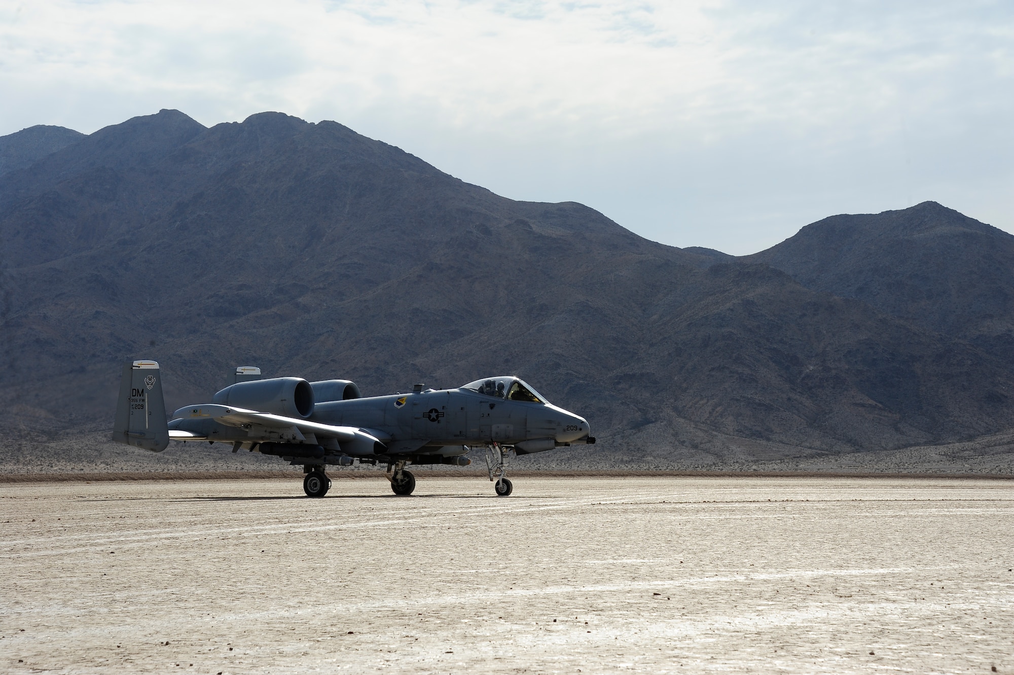 The 355th Fighter Wing flagship sits on the dry lake bed of Bicycle Lake Army Airfield at the National Training Center range, Fort Irwin, Calif., Sept. 22, 2015. The aircraft, along with three other A-10C Thunderbolt IIs from Davis-Monthan Air Force Base, Ariz., landed at the lake bed participating in austere landing training during Green Flag-West 15-10. (U.S. Air Force photo by Senior Airman Betty R. Chevalier/Released)