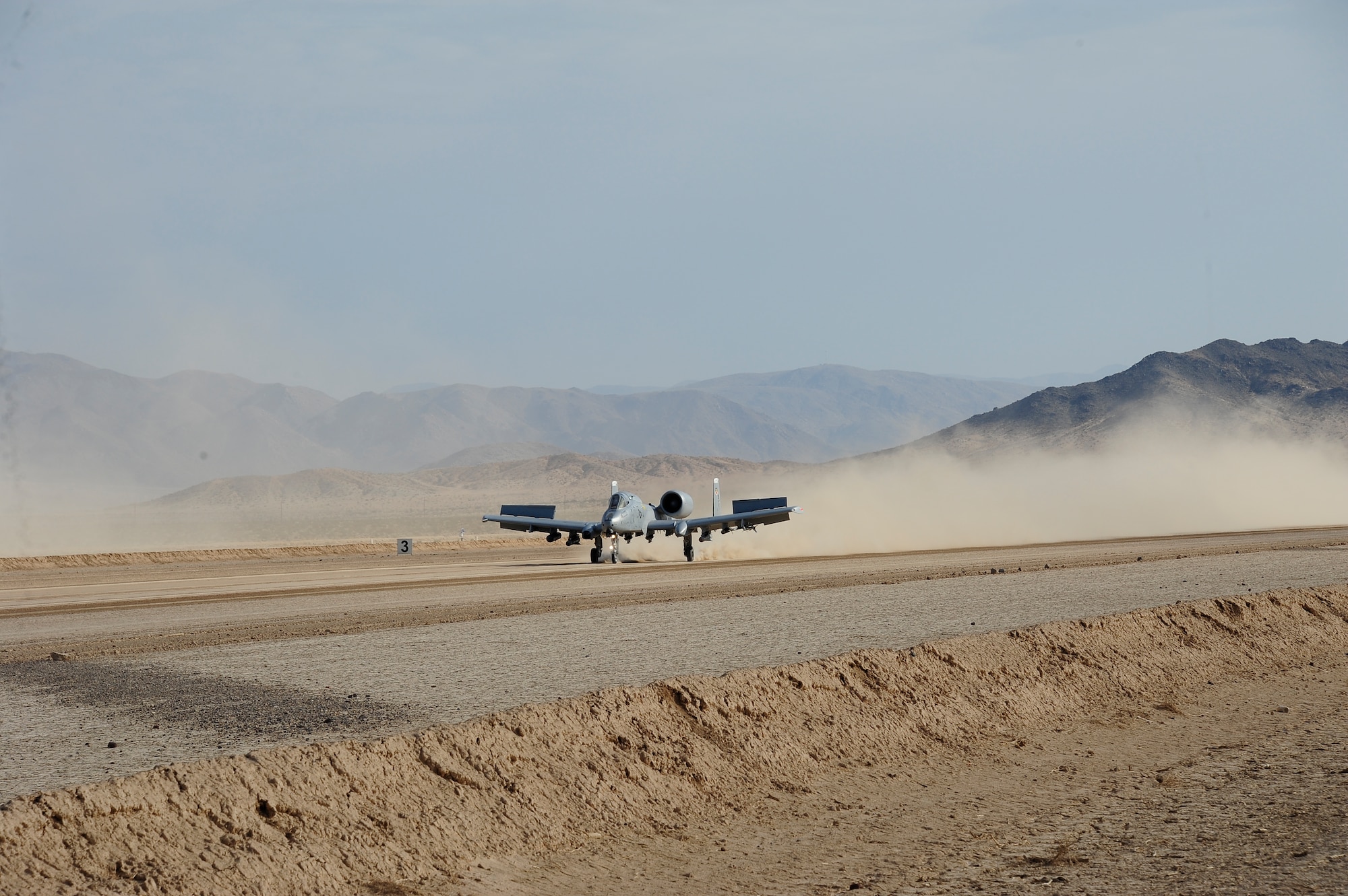 U.S. Air Force Maj. Paul Doran, 357th Fighter squadron pilot, lands an A-10C Thunderbolt II during austere landing training on Bicycle Lake Army Airfield at the National Training Center range, Fort Irwin, Calif., Sept. 22, 2015. Four 357th FS pilots participated in the training, which involved landing and taking off on an unimproved surface, during Green Flag-West 15-10.(U.S. Air Force photo by Senior Airman Betty R. Chevalier/Released)