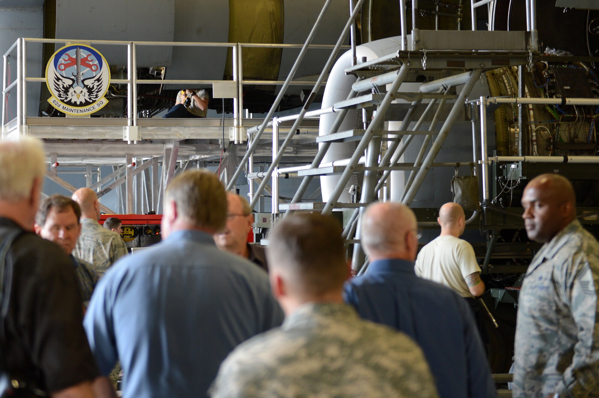 Members of the Vancouver Executive Association receive a tour of the 62nd Maintenance Squadron Sept. 30, 2015, at Joint Base Lewis-McChord, Wash. The 62nd MXS is a 24-hour operation that performs health inspections on all Team McChord C-17 Globemaster III’s weekly, to insure the base stays mission ready. (U.S. Air Force photo/Senior Airman Divine Cox)  