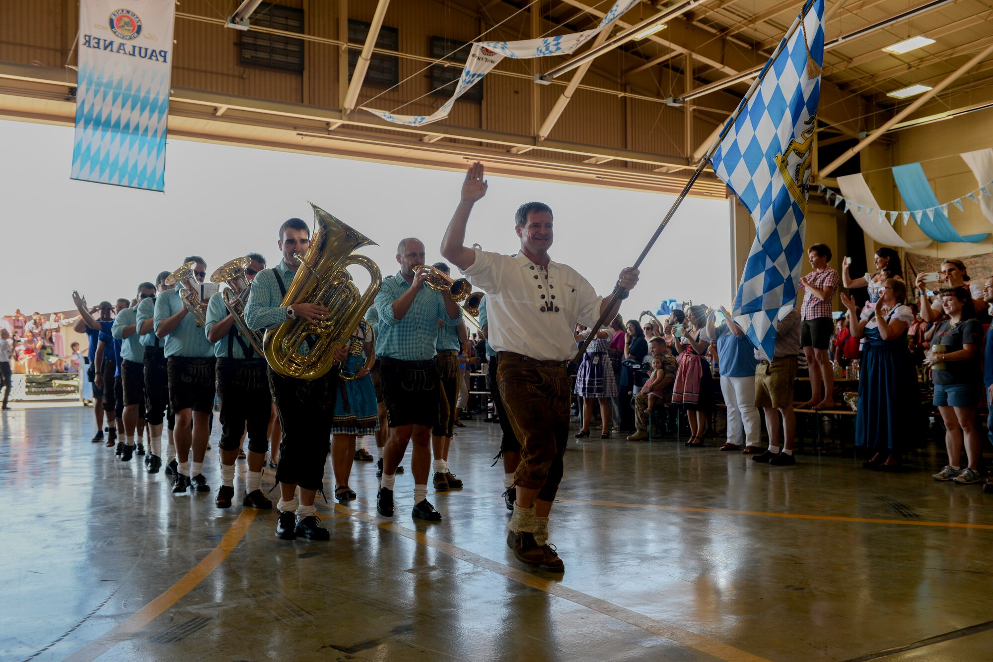 The Pressather Musikanten, musicians from Bavaria, march into a hangar, leading the way for the official party and the tapping of the keg at Holloman Air Force Base, N.M. Sept. 26. The German Air Force hosted their 19th annual Oktoberfest at Holloman, welcoming both military members and the local community on base for the festival. (U.S. Air Force photo by Airman 1st Class Randahl J. Jenson) 
