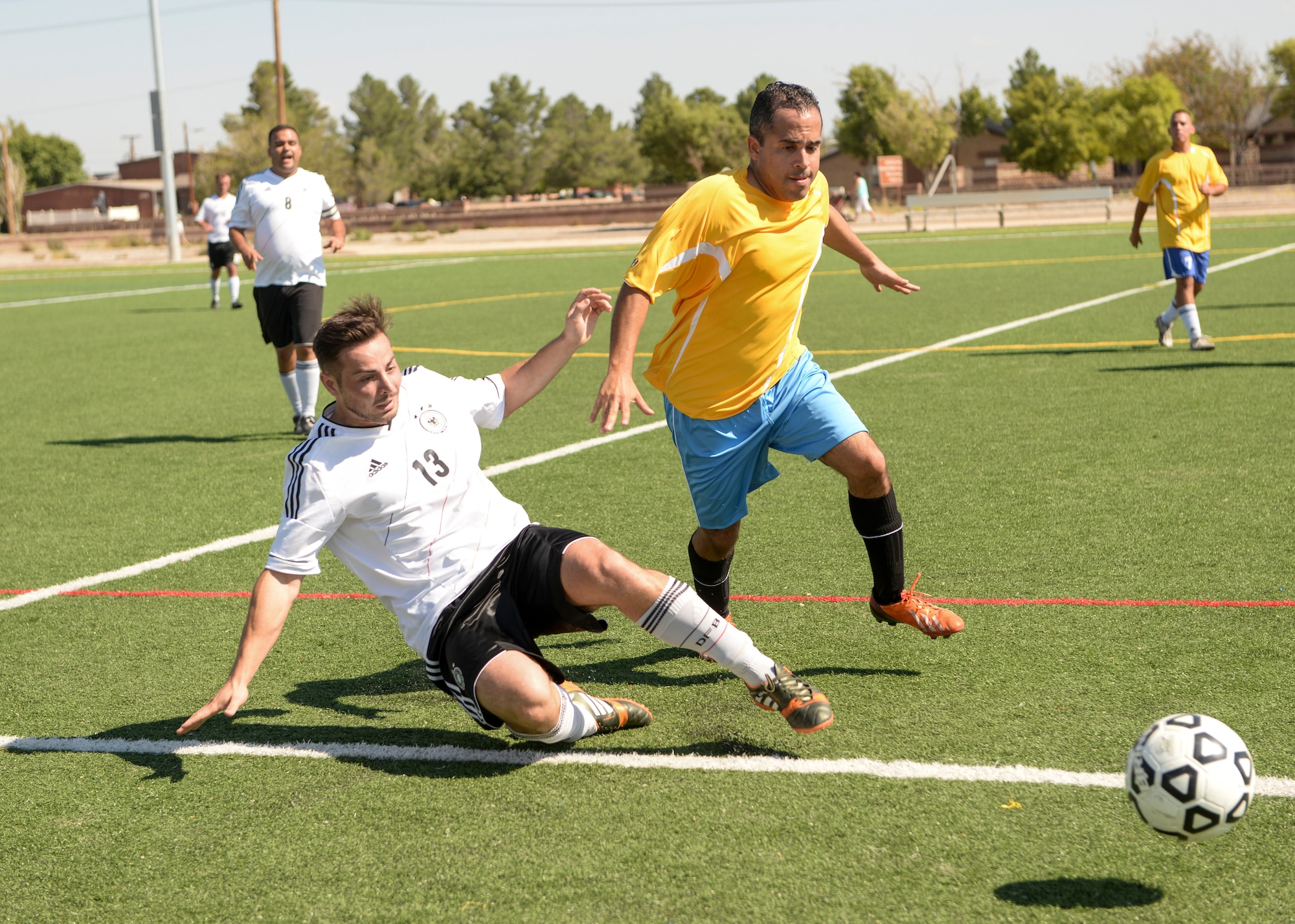 Soccer players from both the German and U.S. Air Force race to the ball during the annual soccer match between the German Air Force and Holloman Airmen at Holloman Air Force Base, N.M. on Sept. 26. The Germans defeated the Holloman team in overtime, 3-2. (U.S. Air Force photo by Airman 1st Class Randahl J. Jenson)
