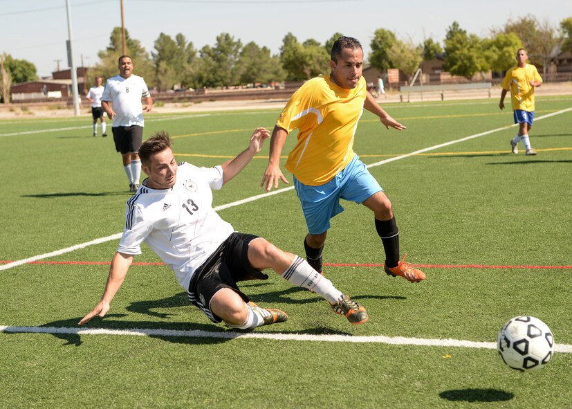 Soccer players from both the German and U.S. Air Force race to the ball during the annual soccer match between the German Air Force and Holloman Airmen at Holloman Air Force Base, N.M. on Sept. 26. The Germans defeated the Holloman team in overtime, 3-2. (U.S. Air Force photo by Airman 1st Class Randahl J. Jenson)
