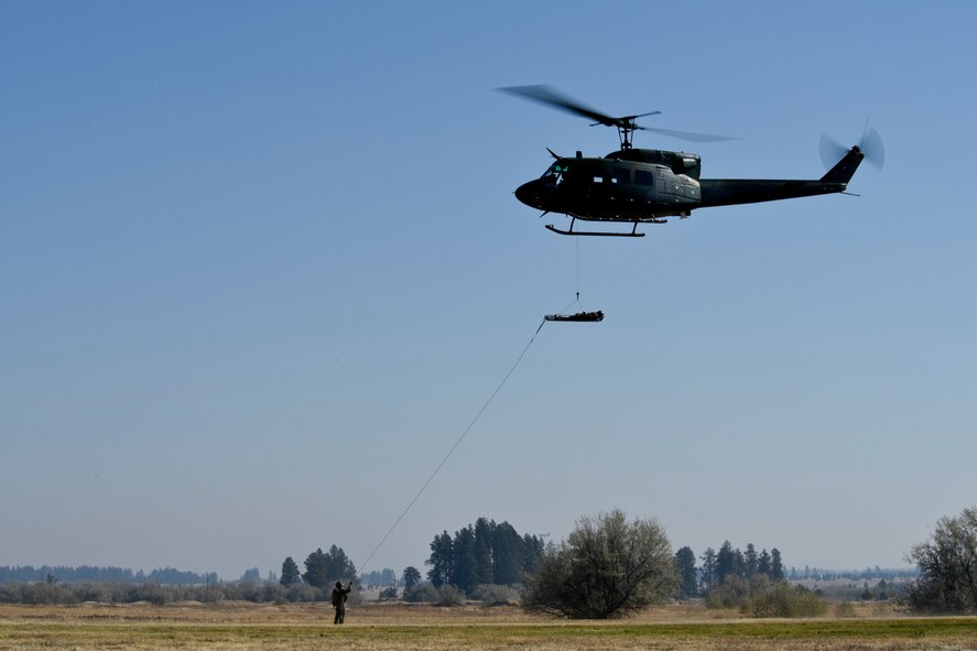 A rescue crew exhibits procedures during a parachute and rescue demonstration Sept. 29, 2015, at Fairchild Air Force Base, Wash. The demonstration was part of a day-long Air Education and Training Command civic leader visit, which was also attended by Lt. Gen. Darryl Roberson, AETC commander. The visit included a water survival training demonstration and a trip to the U.S. Air Force Survival School exhibits lab. (U.S. Air Force photo/Airman 1st Class Mackenzie Richardson)