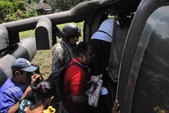 CORONTE, Panama – Victor Luis Pineda, a 30-day-old child, is loaded onto a from Joint Task Force-Bravo helicopter by a representative from the Panamanian Ministry of Health, accompanied by his mother in Coronte, Panama, September 25, 2015, in order to be transported to the Ramballa Air Field, to receive life-saving treatment. Exercises such as these validate medical expeditionary capabilities, enhance readiness and foster partner nation response and capacity. (U.S. Army photo by Sgt. Tia Sokimson) 