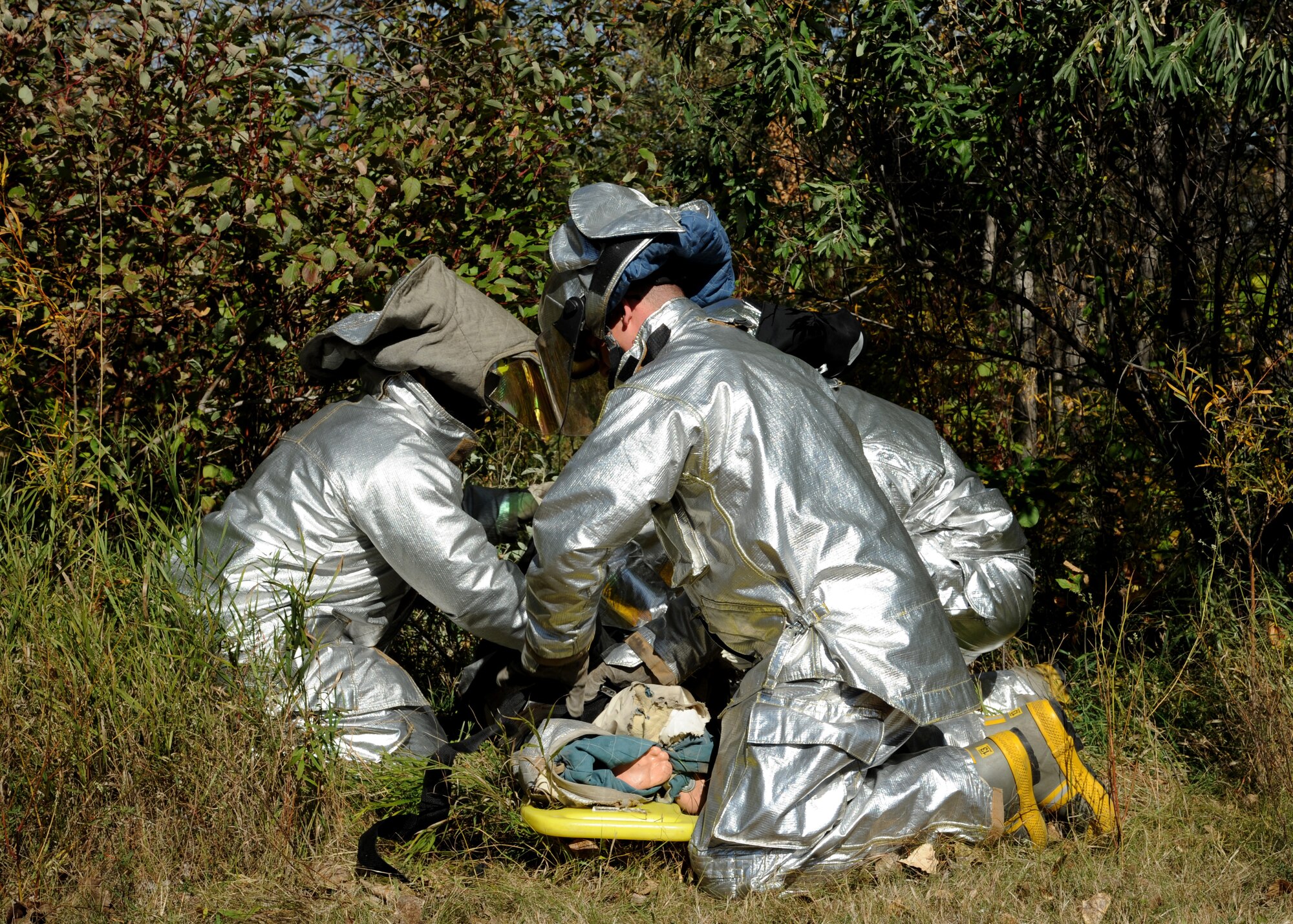 Members of the 319th Civil Engineer Squadron Fire Department, utilize a stretcher to transport a simulated victim during an auto extrication exercise Sept. 29, 2015, on Grand Forks Air Force Base, North Dakota. The scenario involved a victim being trapped in a vehicle while another was thrown from the vehicle. (U.S. Air Force photo by Airman 1st Class Ryan Sparks/Released) 