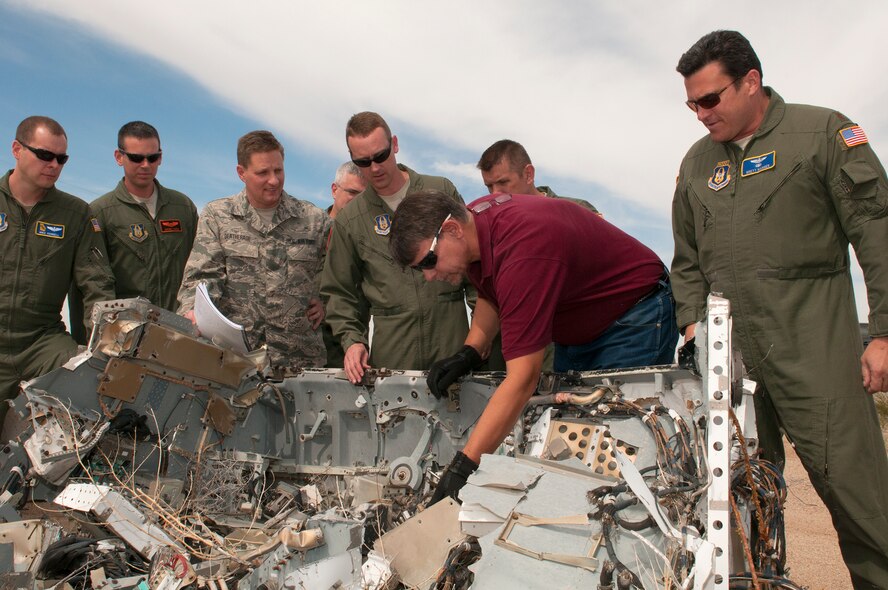 Students of the first all-Reserve class of the Aircraft Mishap Investigation Course look over F-16 mishap indicators at the Air Force Safety Center Crash Lab at Kirtland Air Force Base, N.M., on Sept. 29.  Thirty-two Reservists from 18 installations completed the course taught by the AFSEC Training and Force Development Division, Sept. 14 – Oct. 2.  The course focus on aircraft mishap investigations and analyses of human and material factors prepares Airmen to serve on Class A flight mishap investigation boards.  Shown left to right are:  Capt. Michael Terrell, Dobbins AFB, Ga.; Capt. Jeromy Harris, Barksdale AFB, La.; Senior Master Sgt. Del Deatherage, Scott AFB, Ill; Lt. Col. Joseph Nauman, McChord AFB,  Wash.; Maj. Chris Robinson, Barksdale AFB, La.; Chris Herrmann, AMIC instructor, AFSEC;  Maj. Dennis Mishler, Air Reserve Station, Minn.; and Maj. Brett Manger, Wright-Patterson AFB, Ohio. (U.S. Air Force photo by Lisa Gonzales)