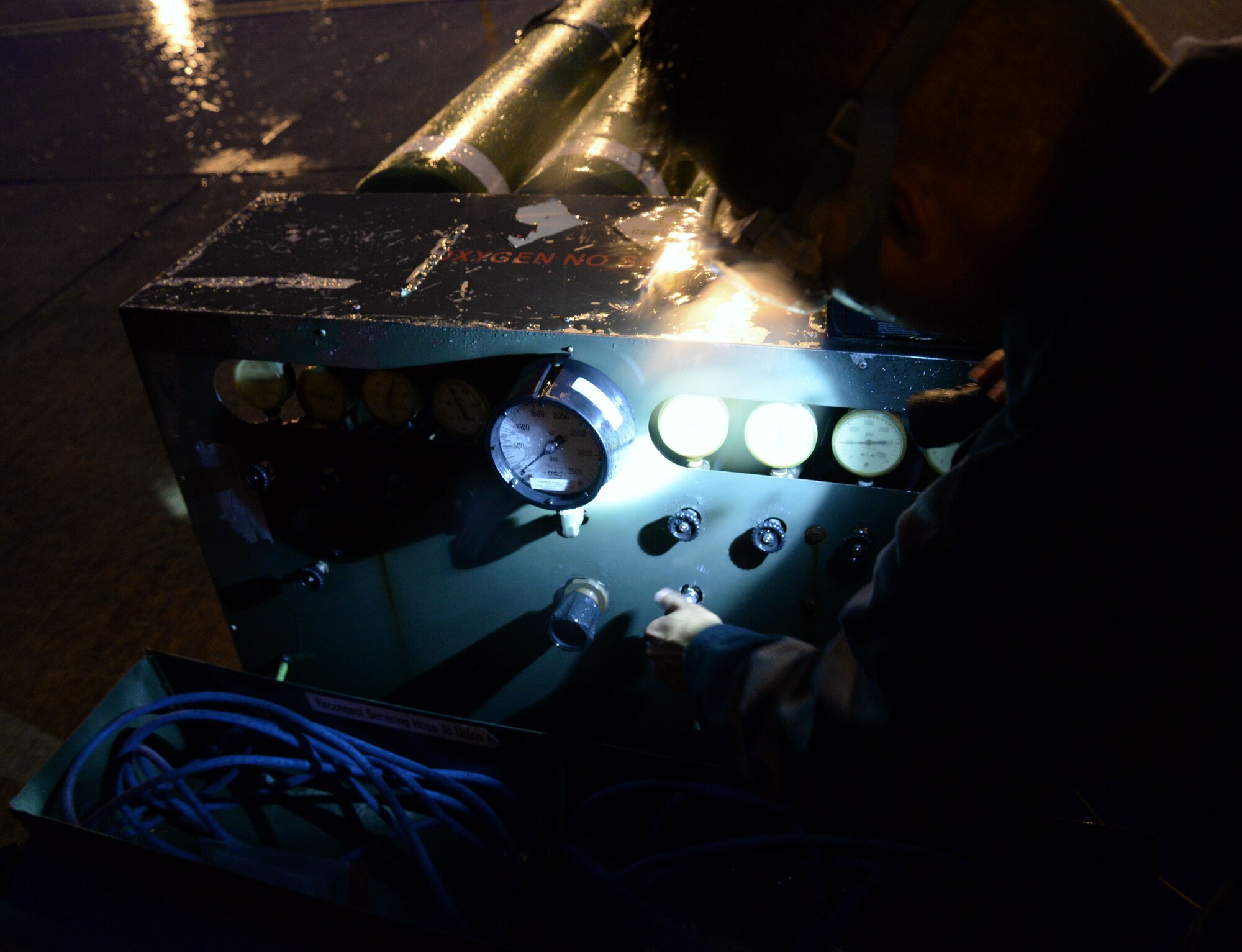 U.S. Air Force Airman 1st Class Erroll James Ponio, 100th Aircraft Maintenance Squadron crew chief, performs gaseous oxygen servicing during pre-flight inspection Sept.16, 2015 on RAF Mildenhall, England. Crew chiefs assigned to the 100th AMXS execute aircraft inspections 24/7, rain or shine. (U.S. Air Force photo by Airman 1st Class Justine Rho/released)