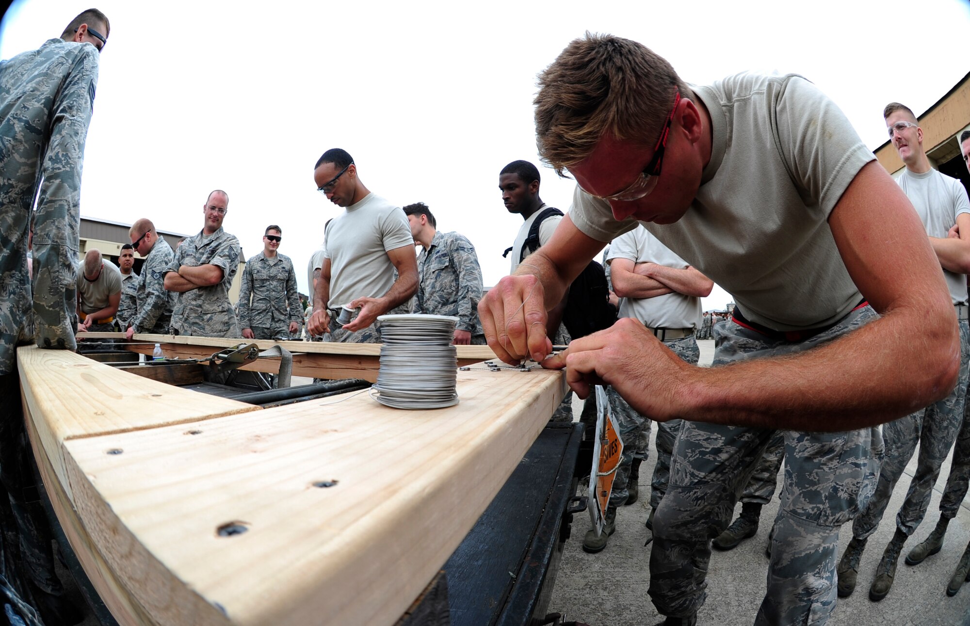 Senior Airman Kaz Cunningham, 158th Fighter Wing F-16 Fighting Falcon crew chief, Vermont Air National Guard, participates in a safety wire challenge during an 8th Maintenance Group Safety Olympics event at Kunsan Air Base, Republic of Korea, Sept. 30, 2015. The purpose of the event was to highlight the importance of workplace safety while simultaneously drawing camaraderie among Airmen. (U.S. Air Force photo by Staff Sgt. Nick Wilson/Released)