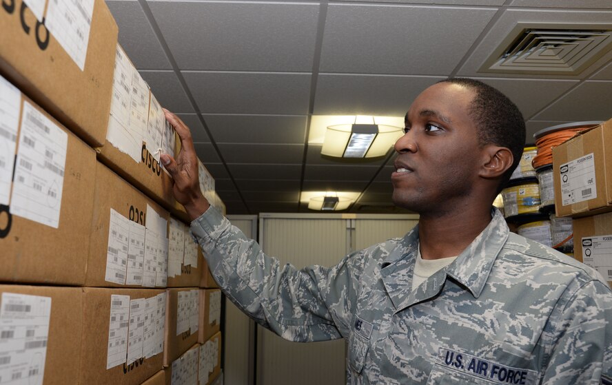 U.S. Air Force Staff Sgt. Christerfer James, 100th Communication Squadron Cyber Transport supervisor, inventories Cisco network switches Sept. 4, 2015, on RAF Mildenhall, England. James was configuring new building switches to allow additional users access to the base network. (U.S. Air Force photo by Gina Randall/Released)