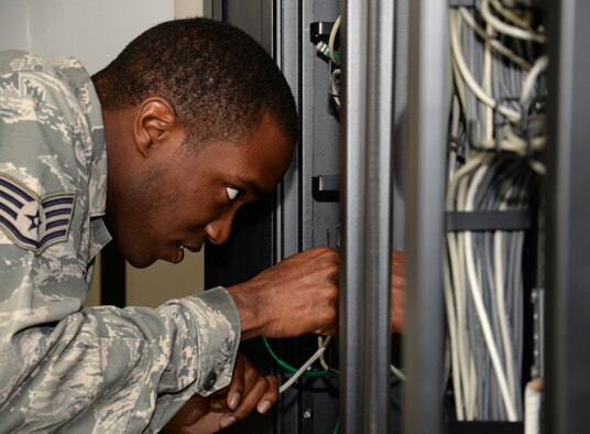 U.S. Air Force Staff Sgt. Christerfer James, 100th Communication Squadron Cyber Transport supervisor, runs cable Sept. 4, 2015, on RAF Mildenhall, England. James was granting RAF Mildenhall users the ability to access the base nonsecure internet protocol router and secure internet protocol router network. (U.S. Air Force photo by Gina Randall/Released)