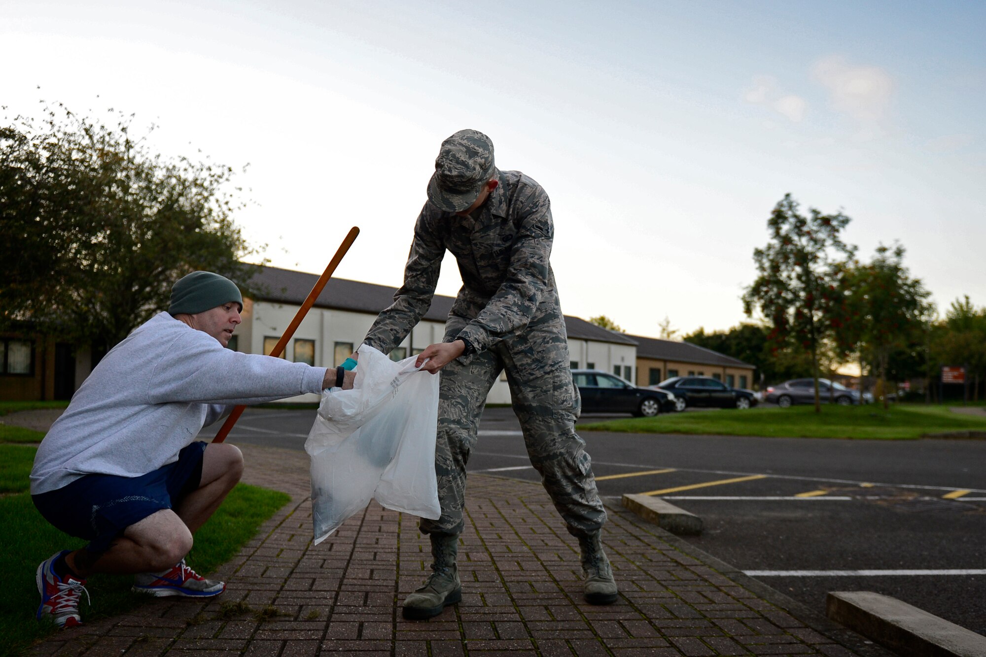 Airmen from the 48th Wing Staff Agency participate in a Base Clean-up event at Royal Air Force Lakenheath, England, Sept. 25, 2015. Keeping the base clean also removes debris that could potential result in foreign object damage incidents. (U.S. Air Force photo by Airman 1st Class Erin R. Babis/Released)