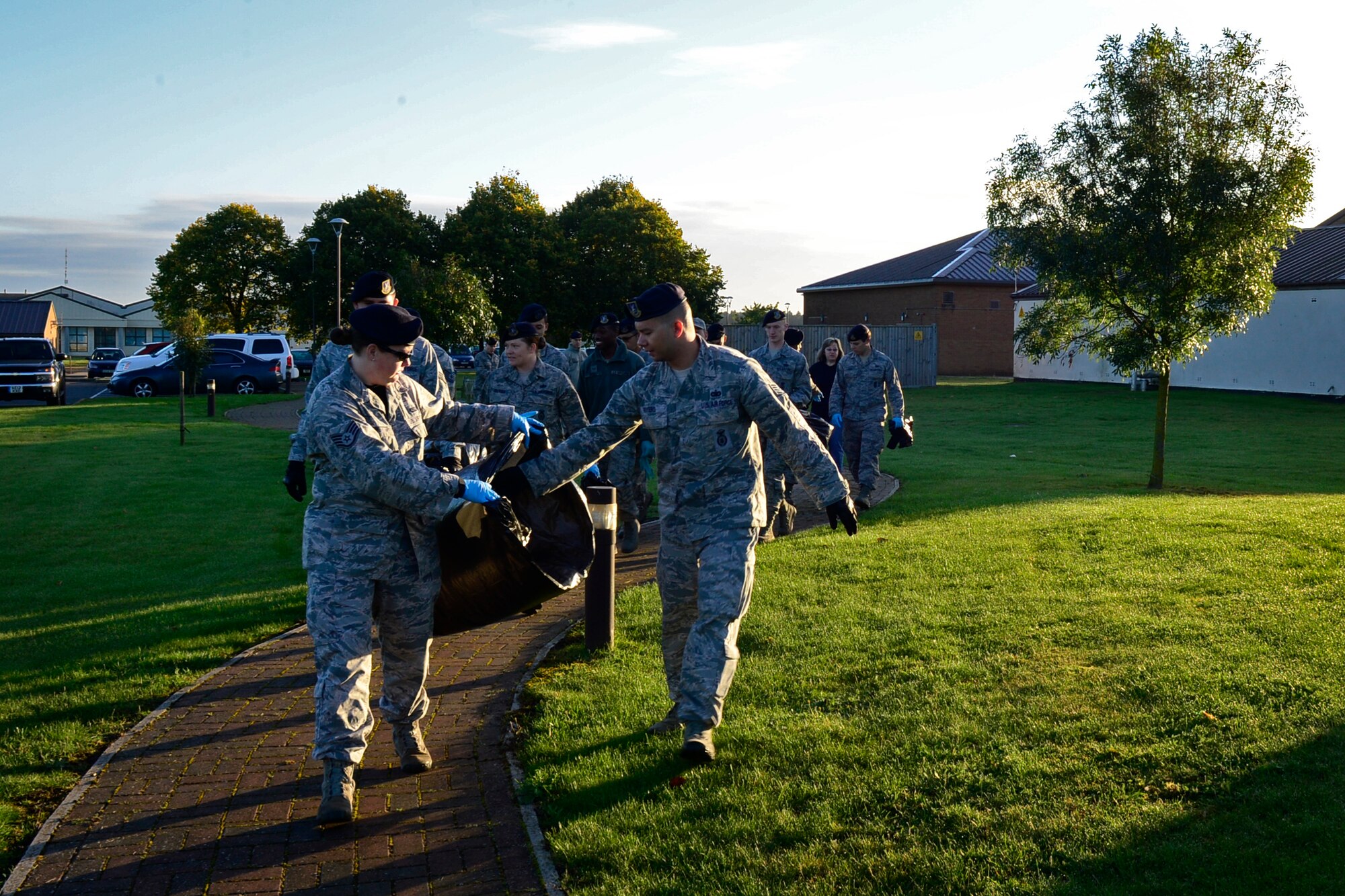 Airmen from the 48th Security Forces Squadron participate in a Base Clean-up event at Royal Air Force Lakenheath, England, Sept. 25, 2015. Keeping the base clean also removes debris that could potential result in foreign object damage incidents. (U.S. Air Force photo by Airman 1st Class Erin R. Babis/Released)