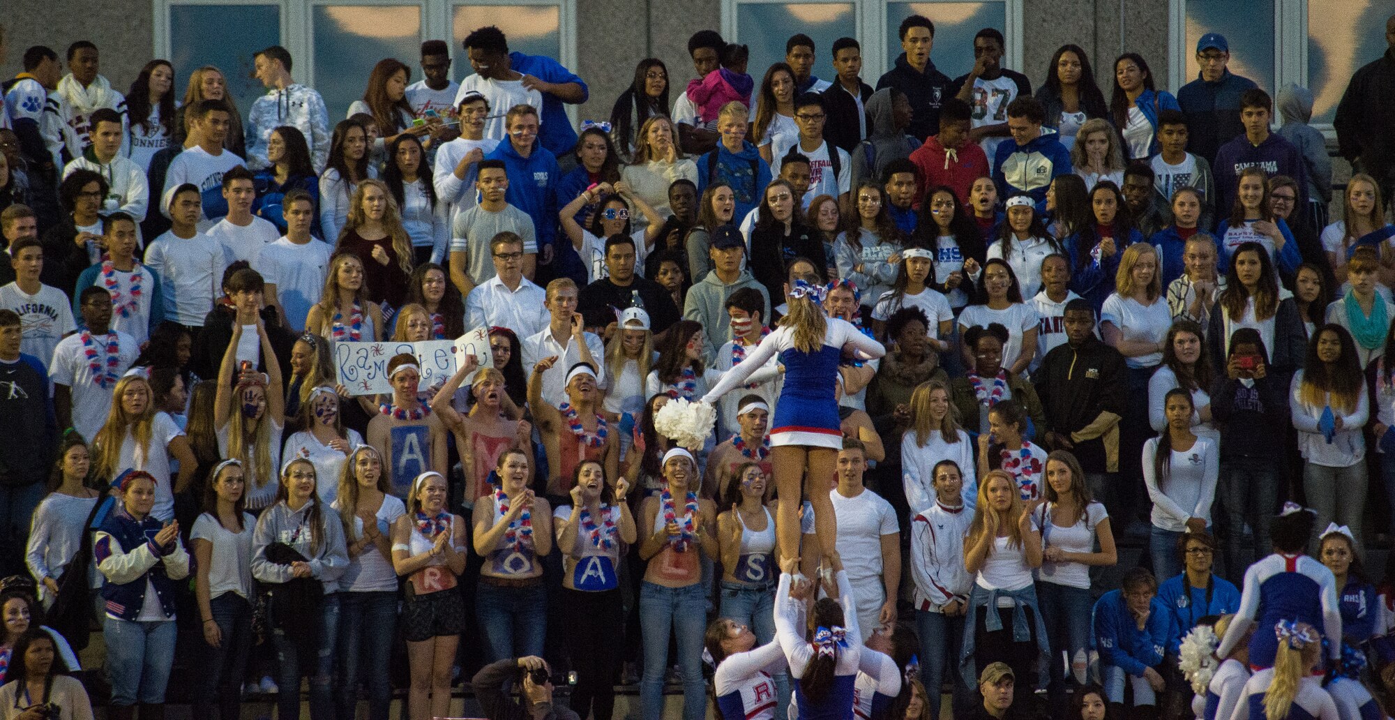 Ramstein Royals’ fans cheer for their team during a game against the Kaiserslautern Raiders Sept. 25, 2015, at Vogelweh Military Complex, Germany. Fans came out to watch both the junior varsity and varsity football teams play. The Royals junior varsity lost against the Raiders, but the varsity pulled off a 27-14 victory. (U.S. Air Force photo/Senior Airman Damon Kasberg)