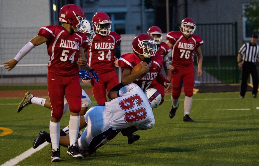 Clesson Allman, Ramstein Royals defensive tackle, tackles Jayden Jones, Kaiserslautern Raiders quarterback, Sept. 25, 2015, at Vogelweh Military Complex, Germany. The Royals defense caused multiple turnovers, helping them earn a 27-14 victory over the Raiders. (U.S. Air Force photo/Senior Airman Damon Kasberg)