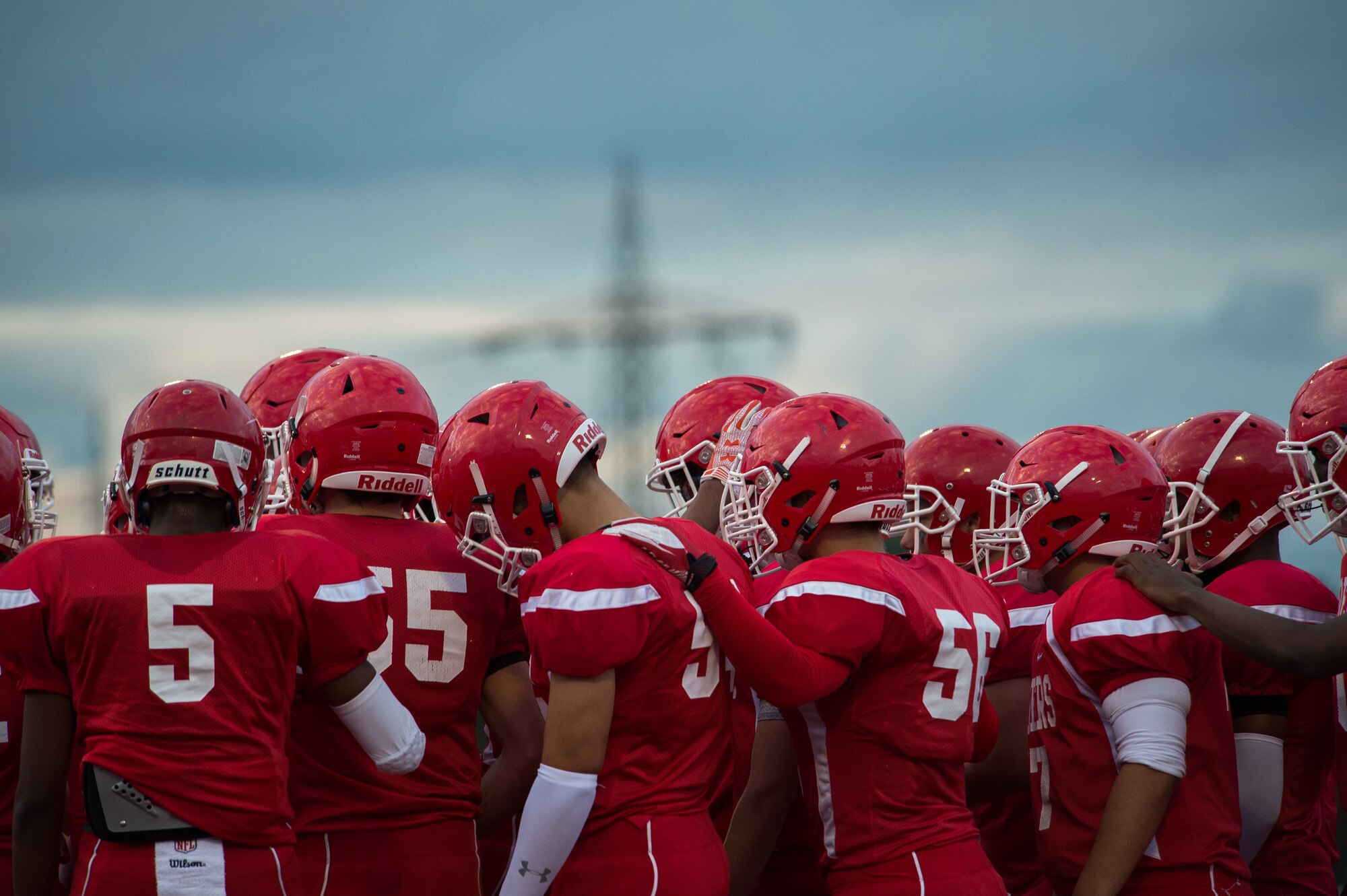 Members of the Kaiserslautern Raiders huddle together before their game Sept. 25, 2015, at Vogelweh Military Complex, Germany. Prior to the game, Kaiserslautern High School held a ceremony to recognize its senior athletes. This included 11 of its football players. (U.S. Air Force photo/Senior Airman Damon Kasberg)