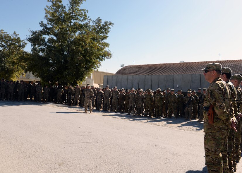 Airmen of the 455th Air Expeditionary Wing gather to pay their respect and mourn the loss of six Airmen during a fallen comrade memorial ceremony Oct. 3, 2015, at Bagram Airfield, Afghanistan. The six Airmen, four who were pilots and crew members, Capts. Jordan Pierson and Jonathan Golden, Staff Sgt. Ryan Hammond and Senior Airman Quinn Johnson-Harris, and two who were security forces fly away security team members, Airman 1st Class Kcey Ruiz and Senior Airman Nathan Sartain, lost their lives when their C-130J crashed shortly after take-off from Jalalabad Airfield in Afghanistan, Oct. 2, 2015. (U.S. Air Force photo by Senior Airman Cierra Presentado/Released)