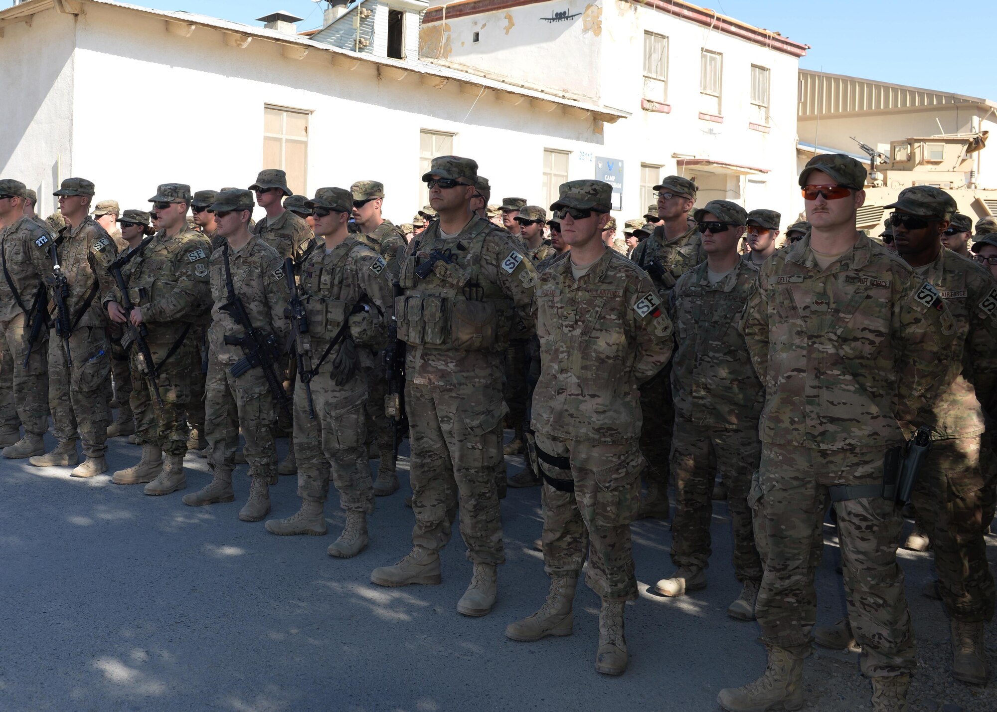 Airmen of the 455th Air Expeditionary Wing gather to pay their respect and mourn the loss of six Airmen during a fallen comrade memorial ceremony Oct. 3, 2015, at Bagram Airfield, Afghanistan. The six Airmen, four who were pilots and crew members, Capts. Jordan Pierson and Jonathan Golden, Staff Sgt. Ryan Hammond and Senior Airman Quinn Johnson-Harris, and two who were security forces fly away security team members, Airmen 1st Class Kcey Ruiz and Senior Airman Nathan Sartain, lost their lives when their C-130J crashed shortly after take-off from Jalalabad Airfield in Afghanistan, Oct. 2, 2015. (U.S. Air Force photo by Senior Airman Cierra Presentado/Released)