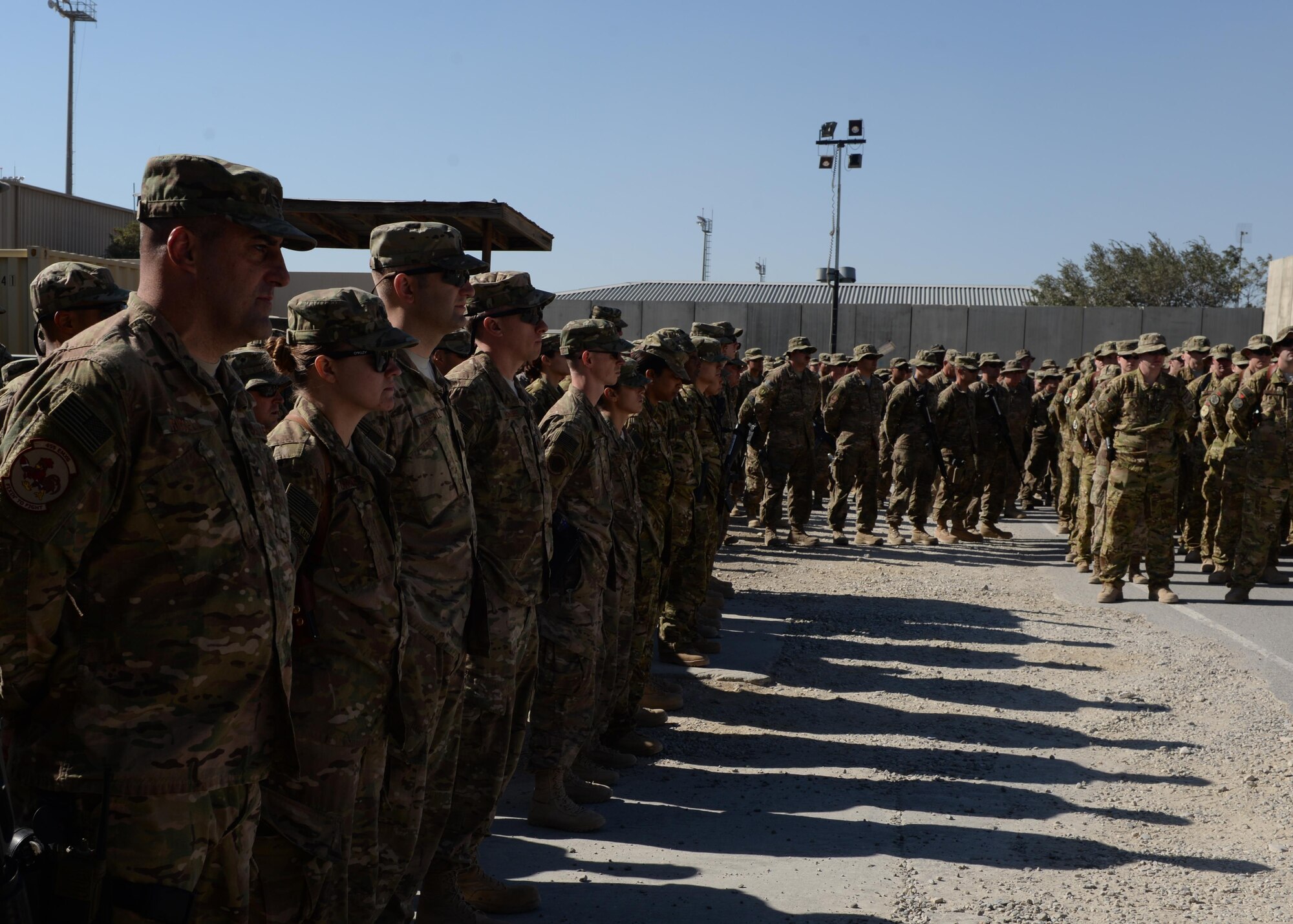 Airmen of the 455th Air Expeditionary Wing gather to pay their respect and mourn the loss of six Airmen during a fallen comrade memorial ceremony Oct. 3, 2015, at Bagram Airfield, Afghanistan. The six Airmen, four who were pilots and crew members, Capts. Jordan Pierson and Jonathan Golden, Staff Sgt. Ryan Hammond and Senior Airman Quinn Johnson-Harris, and two who were security forces fly away security team members, Airman 1st Class Kcey Ruiz and Senior Airman Nathan Sartain, lost their lives when their C-130J crashed shortly after take-off from Jalalabad Airfield in Afghanistan, Oct. 2, 2015. (U.S. Air Force photo by Senior Airman Cierra Presentado/Released)