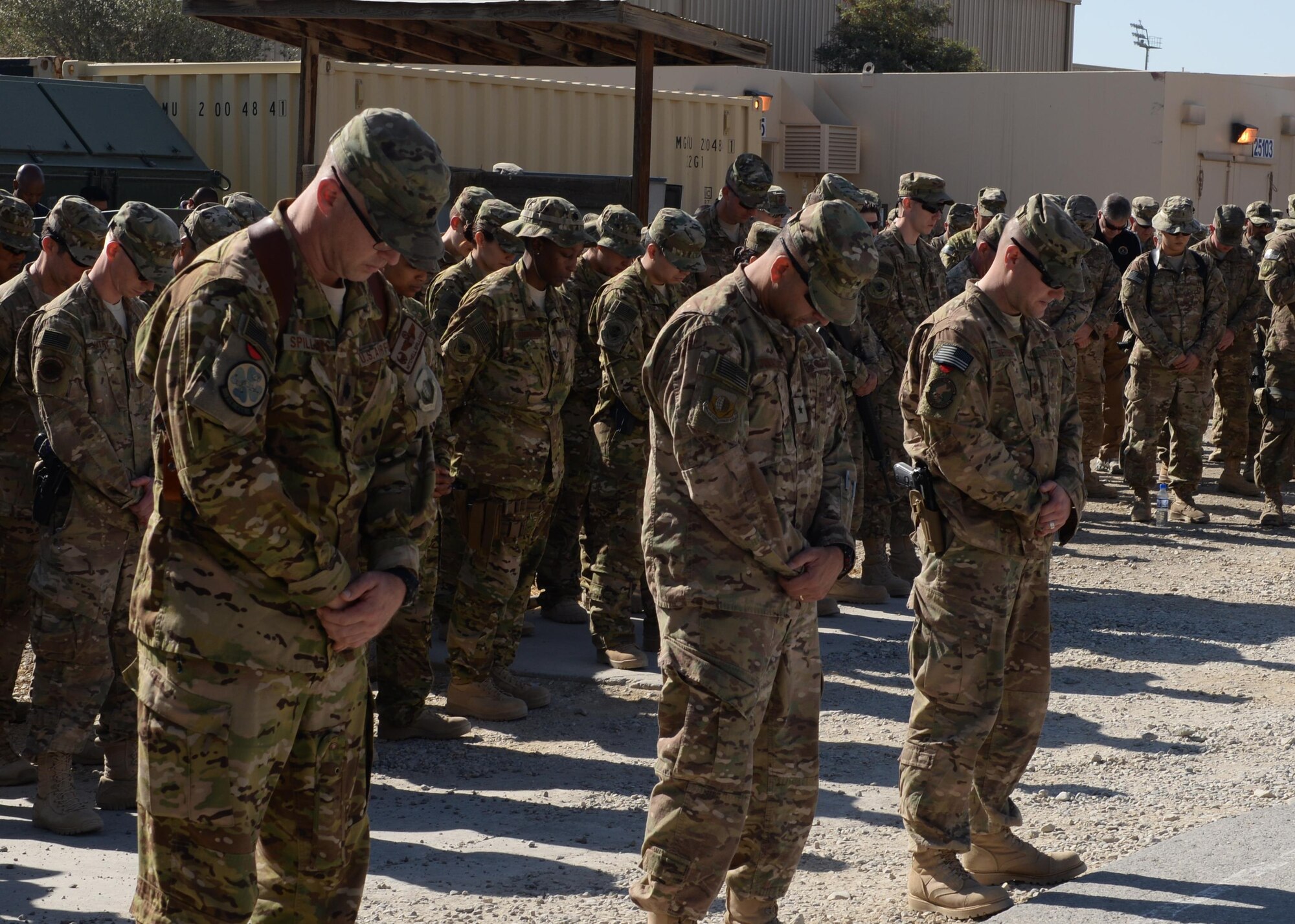 Brig. Gen. Dave Julazadeh (center), 455th Air Expeditionary Wing commander, Lt. Col. Mitchell Spillers (left), 774th Expeditionary Airlift Squadron commander, Maj. Met Berisha (right), 455th Expeditionary Security Forces Squadron commander, and Airmen of the 455th Air Expeditionary Wing gather to pay their respect and mourn the loss of six Airmen during a fallen comrade memorial ceremony Oct. 3, 2015, at Bagram Airfield, Afghanistan. The six Airmen, four who were pilots and crew members, Capts. Jordan Pierson and Jonathan Golden, Staff Sgt. Ryan Hammond and Senior Airman Quinn Johnson-Harris, and two who were security forces fly away security team members, Airman 1st Class Kcey Ruiz and Senior Airman Nathan Sartain, lost their lives when their C-130J crashed shortly after take-off from Jalalabad Airfield in Afghanistan, Oct. 2, 2015. (U.S. Air Force photo by Senior Airman Cierra Presentado/Released)