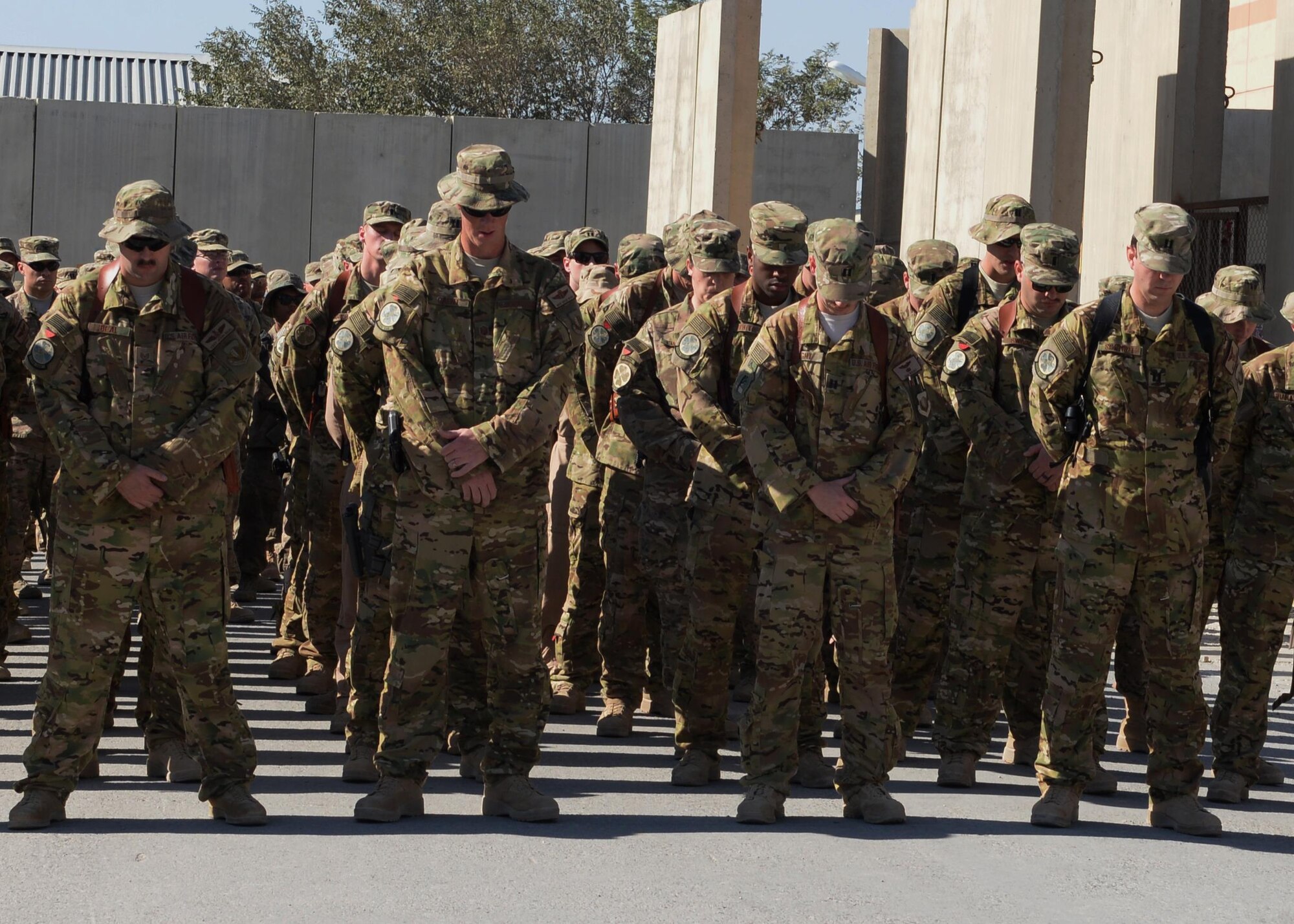 Airmen from the 774th Expeditionary Airlift Squadron gather at a fallen comrade memorial ceremony to mourn the loss of six Airmen Oct. 3, 2015, at Bagram Airfield, Afghanistan. The six Airmen, four who were pilots and crew members, Capts. Jordan Pierson and Jonathan Golden, Staff Sgt. Ryan Hammond and Senior Airman Quinn Johnson-Harris, and two who were security forces fly away security team members, Airman 1st Class Kcey Ruiz and Senior Airman Nathan Sartain, lost their lives when their C-130J crashed shortly after take-off from Jalalabad Airfield in Afghanistan, Oct. 2, 2015. (U.S. Air Force photo by Senior Airman Cierra Presentado/Released)