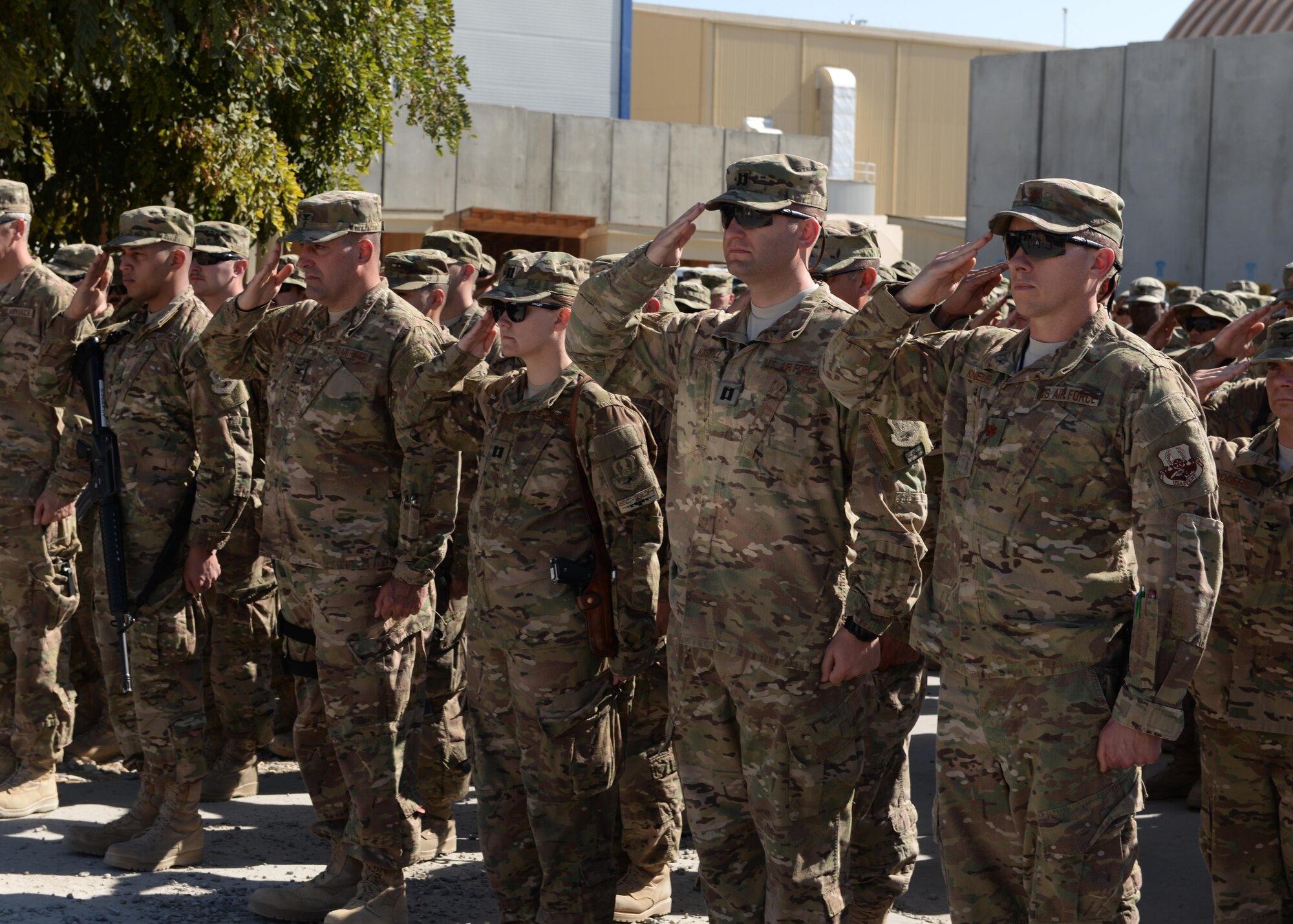 Airmen of the 455th Air Expeditionary Wing salute during a fallen comrade memorial ceremony to mourn the loss of six Airmen Oct. 3, 2015, at Bagram Airfield, Afghanistan. The six Airmen, four who were pilots and crew members, Capts. Jordan Pierson and Jonathan Golden, Staff Sgt. Ryan Hammond and Senior Airman Quinn Johnson-Harris, and two who were security forces fly away security team members, Airman 1st Class Kcey Ruiz and Senior Airman Nathan Sartain, lost their lives when their C-130J crashed shortly after take-off from Jalalabad Airfield in Afghanistan, Oct. 2, 2015. (U.S. Air Force photo by Senior Airman Cierra Presentado/Released)