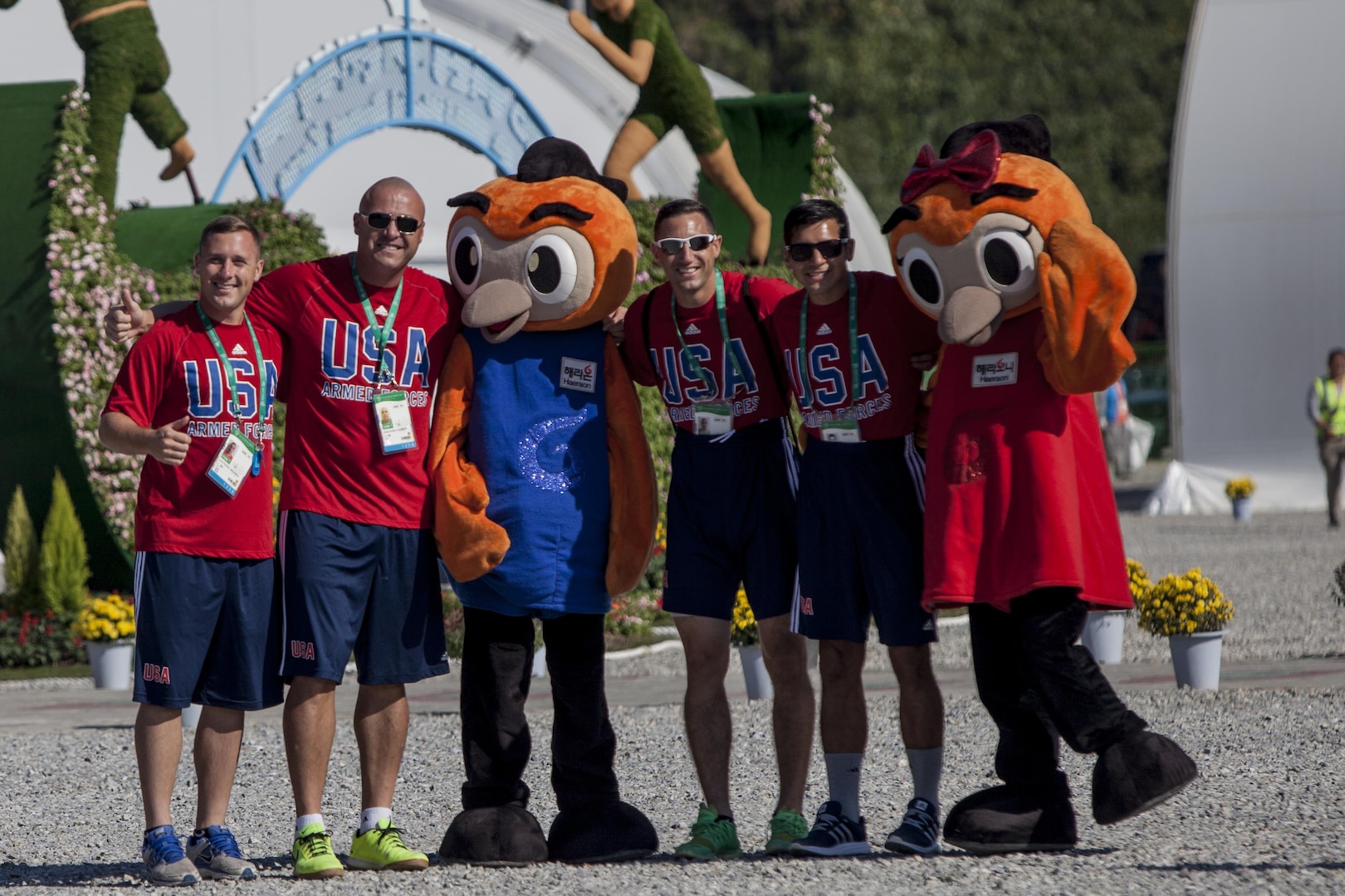 United States Men’s Soccer Team Members pose for pictures with the Mascots for the 2015 6th CISM World Games during the Athlete Village Opening Ceremony. The CISM World Games provides the opportunity for the athletes of over 100 different Nations to come together and enjoy friendship through sport. The sixth annual CISM World Games are being held aboard Mungyeong, South Korea., Sept. 30 - Oct. 11.  (Photo by Sgt. Ashley N. Cano)