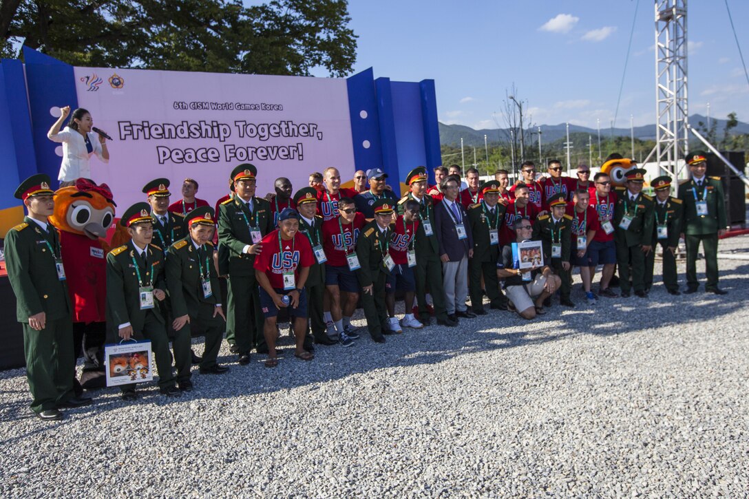 United States Men’s Soccer Team pose for pictures with the Vietnamese Athletes during the 2015 6th CISM World Games, Athlete Village Opening Ceremony. The CISM World Games provides the opportunity for the athletes of over 100 different nations to come together and enjoy friendship through sport. The sixth annual CISM World Games are being held aboard Mungyeong, South Korea., Sept. 30 - Oct. 11.  (Photo by Sgt. Ashley N. Cano)
