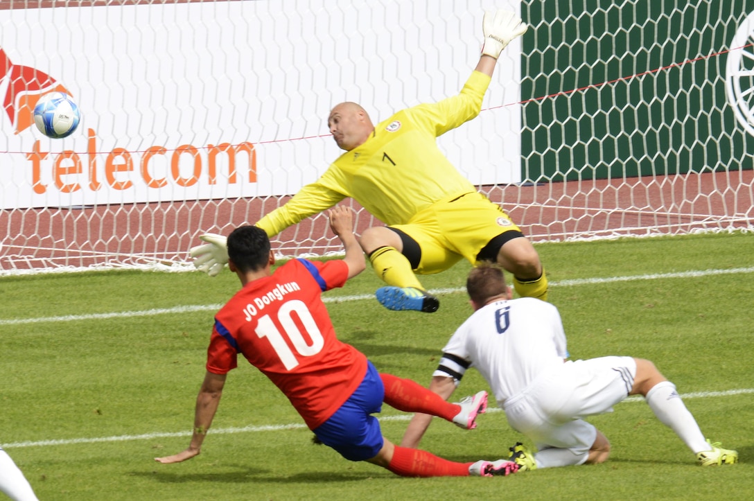 USA goalkeeper Staff Sgt. Joshua Blodgett leaps to try and stop a shot by Korea's Jo Dongkun during the opening competition of the CISM World Games in Mungyeong, South Korea, Sept. 30, 2015.