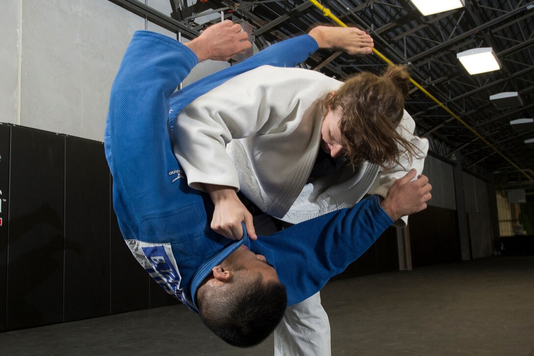 Missouri Army National Guard Capt. Anna Feygina throws Navy Petty Officer 2nd Class Bobby Yamashita during U.S. Armed Forces Tae Kwon Do Team practice at Fort Indiantown Gap, Pa., Sept. 21, 2015. The team is training for the 2015 Military World Games in Mungyeong, South Korea, scheduled for Oct. 2 through Oct. 11. (DoD News photo by EJ Hersom)