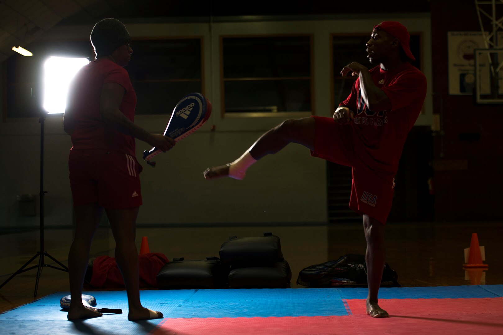Army National Guard Sgt. Lamonte Kelly, right, kicks a target held by Army Staff Sgt. Ashley Sadlowski during U.S. Armed Forces Tae Kwon Do Team practice at Fort Indiantown Gap, Pa., Sept. 21, 2015. The team is training for the 2015 Military World Games in Mungyeong, South Korea, scheduled for Oct. 2 through Oct. 11. (DoD News photo by EJ Hersom)