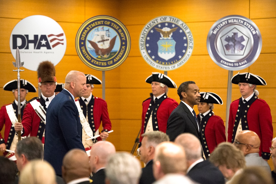 Assistant Secretary of Defense for Health Affairs Dr. Jonathan Woodson, front right, and Air Force Lt. Gen. (Dr.) Douglas J. Robb, director of the Defense Health Agency, walk past members of The Old Guard ceremonial unit at the conclusion of DHA's second anniversary celebration in Falls Church, Va., Oct. 1, 2015. DoD photo by EJ Hersom