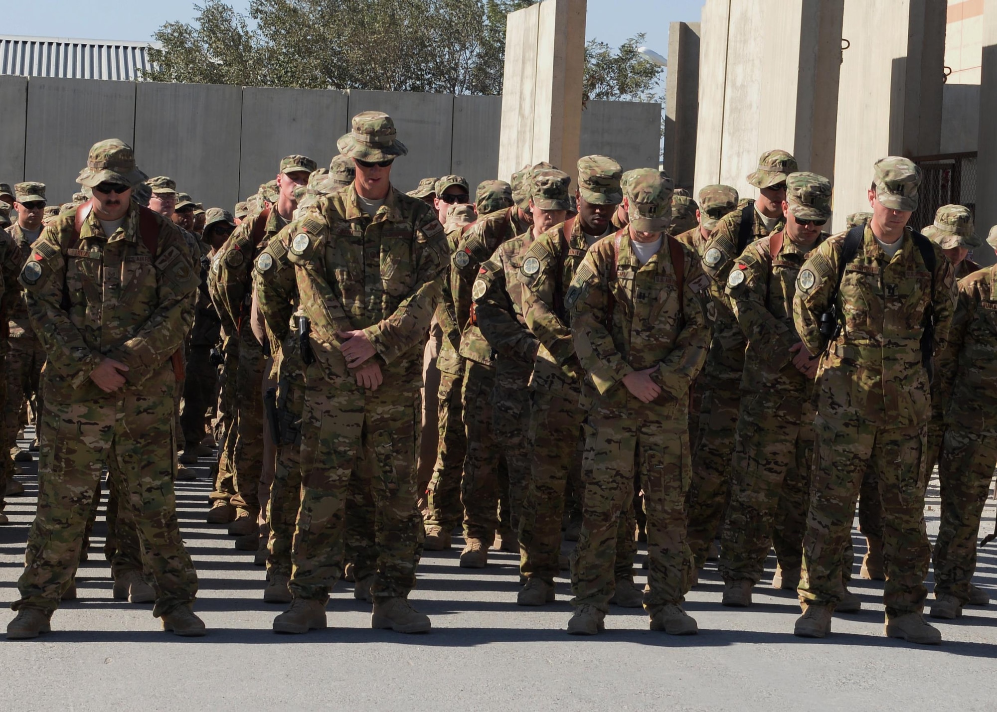 Airmen from the 774th Expeditionary Airlift Squadron gather at a fallen comrade memorial ceremony Oct. 3, 2015, at Bagram Airfield, Afghanistan. Six Airmen lost their lives when their C-130J Super Hercules crashed shortly after takeoff from Jalalabad Airfield in Afghanistan, Oct. 2, 2015. Capts. Jordan Pierson and Jonathan Golden, Staff Sgt. Ryan Hammond and Senior Airman Quinn Johnson-Harris were pilots and crew members. Airman 1st Class Kcey Ruiz and Senior Airman Nathan Sartain were security forces fly away security team members. (U.S. Air Force photo/Senior Airman Cierra Presentado) 