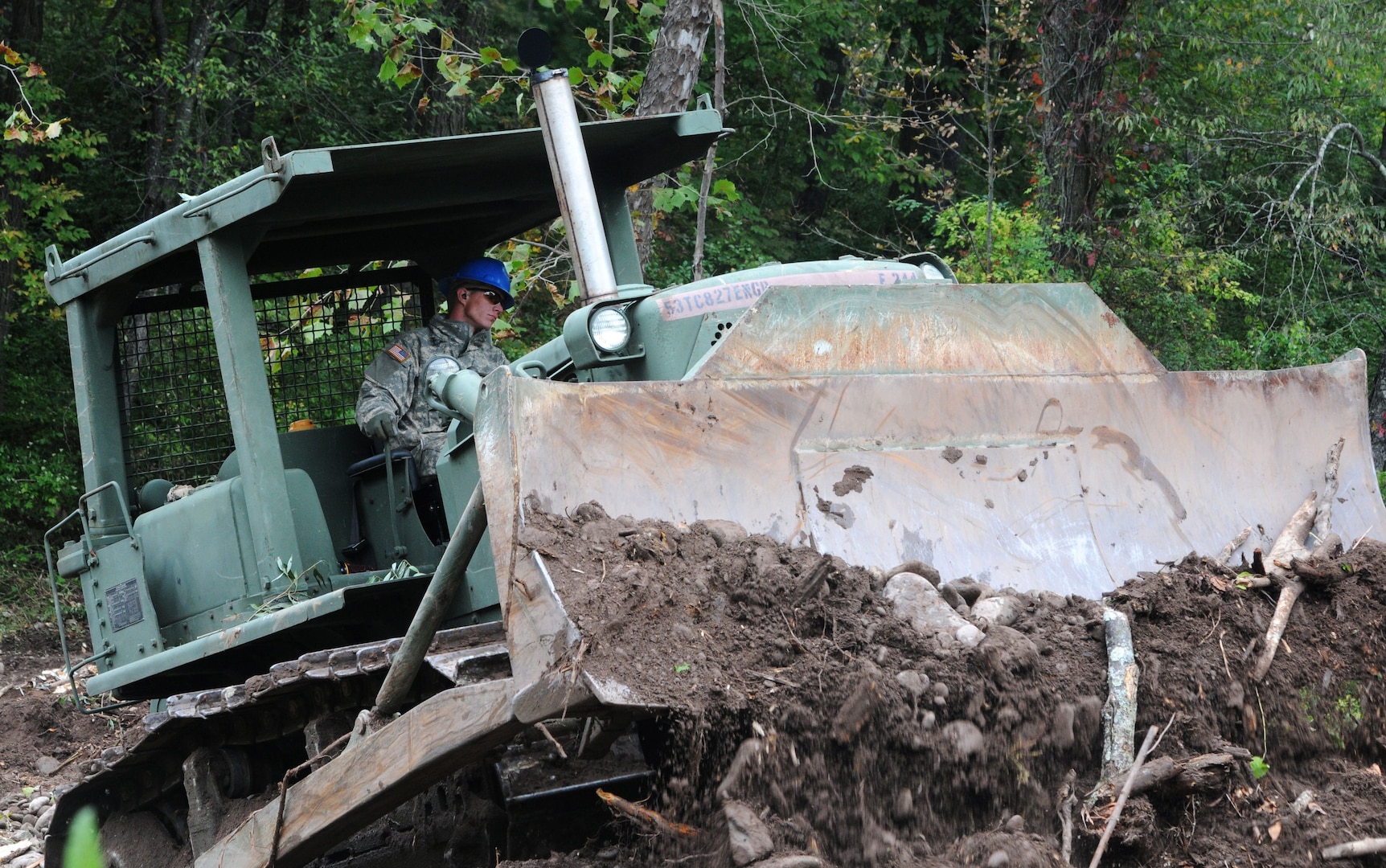 Spc. Dakota Nelson, a heavy equipment operator with the 827th Engineer Company in the New York Army National Guard, operates a D7 Bulldozer as part of the debris cleanup mission in preparation for Hurricane Joaquin, Oct. 2, 2015. The National Guard engineers worked with the Department of Environmental Conservation to clear debris from streams prone to flooding. 