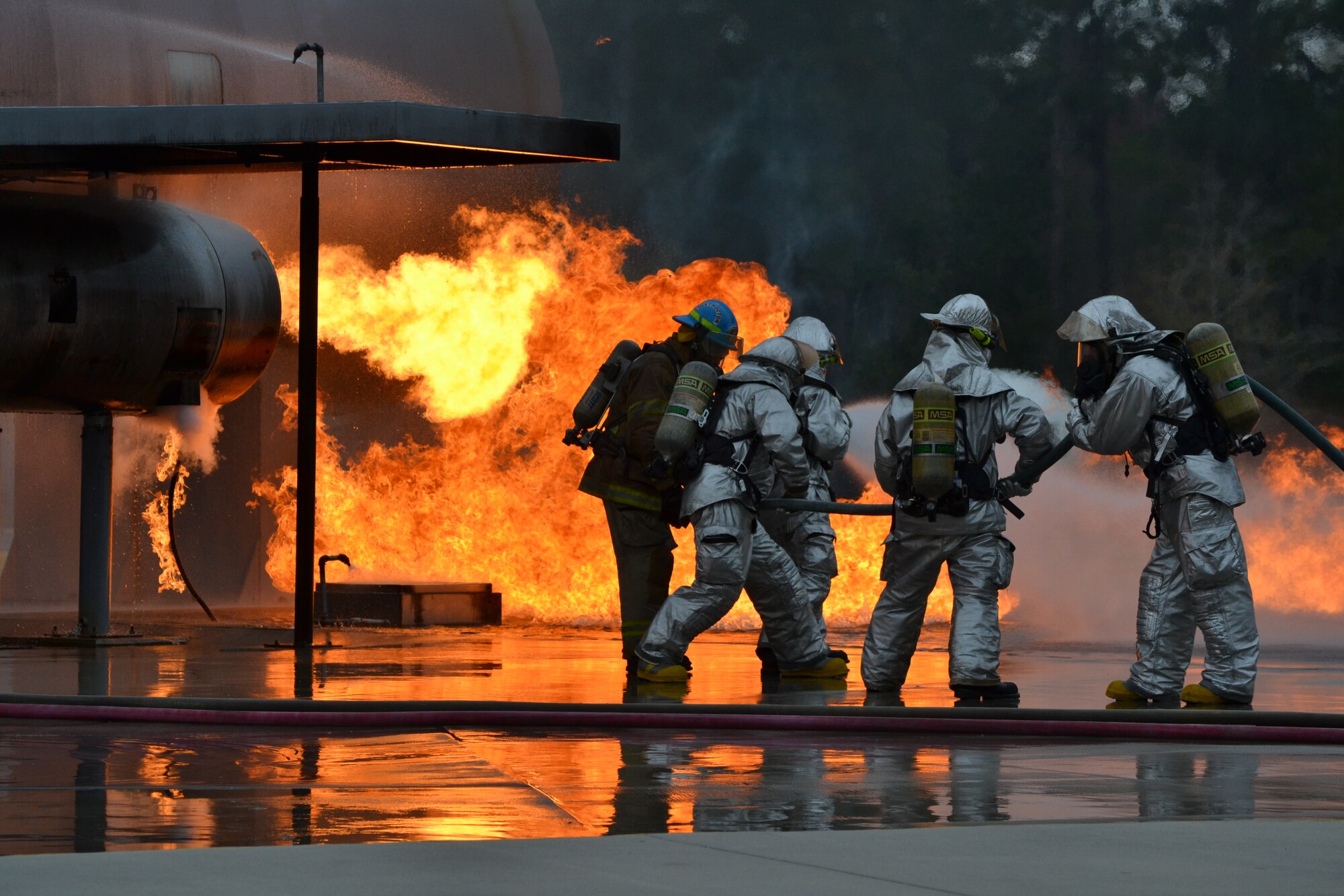 Firefighters from the 120th Airlift Wing practice putting out a simulated aircraft engine fire at the Fire Academy of the South. Thirty-eight members of the Montana Air National Guard deployed to Jacksonville, Fla., and integrated with the Florida Air National Guard for two weeks of specialty training in February 2015.  (U.S. Air National Guard photo/Master Sgt. Anthony Barille)