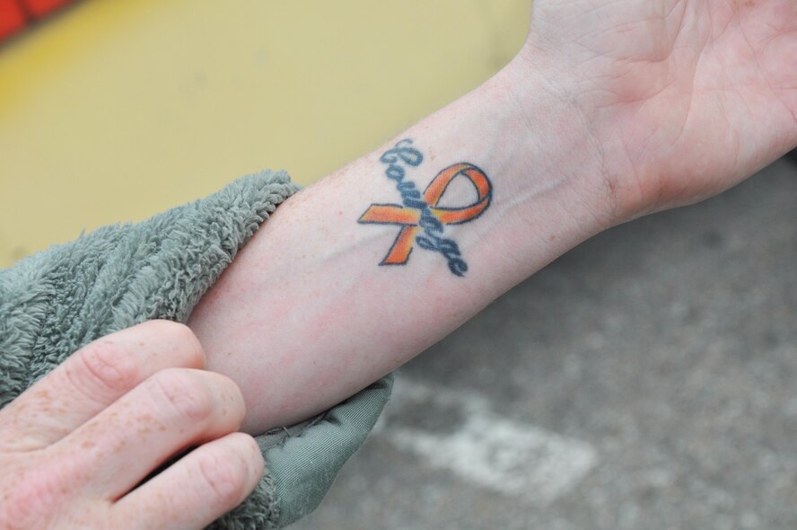 Tech. Sgt. Stacey Spain, 931st Air Refueling Group Emergency Management NCOIC, shows off a Leukemia Awareness Ribbon tattoo, Oct. 3, 2015, at McConnell Air Force Base, Kan. Spain got the tattoo in honor of her niece, Mackenzie, who was diagnosed with Acute Myeloid Leukemia. (U.S. Air Force photo by Tech. Sgt. Abigail Klein)