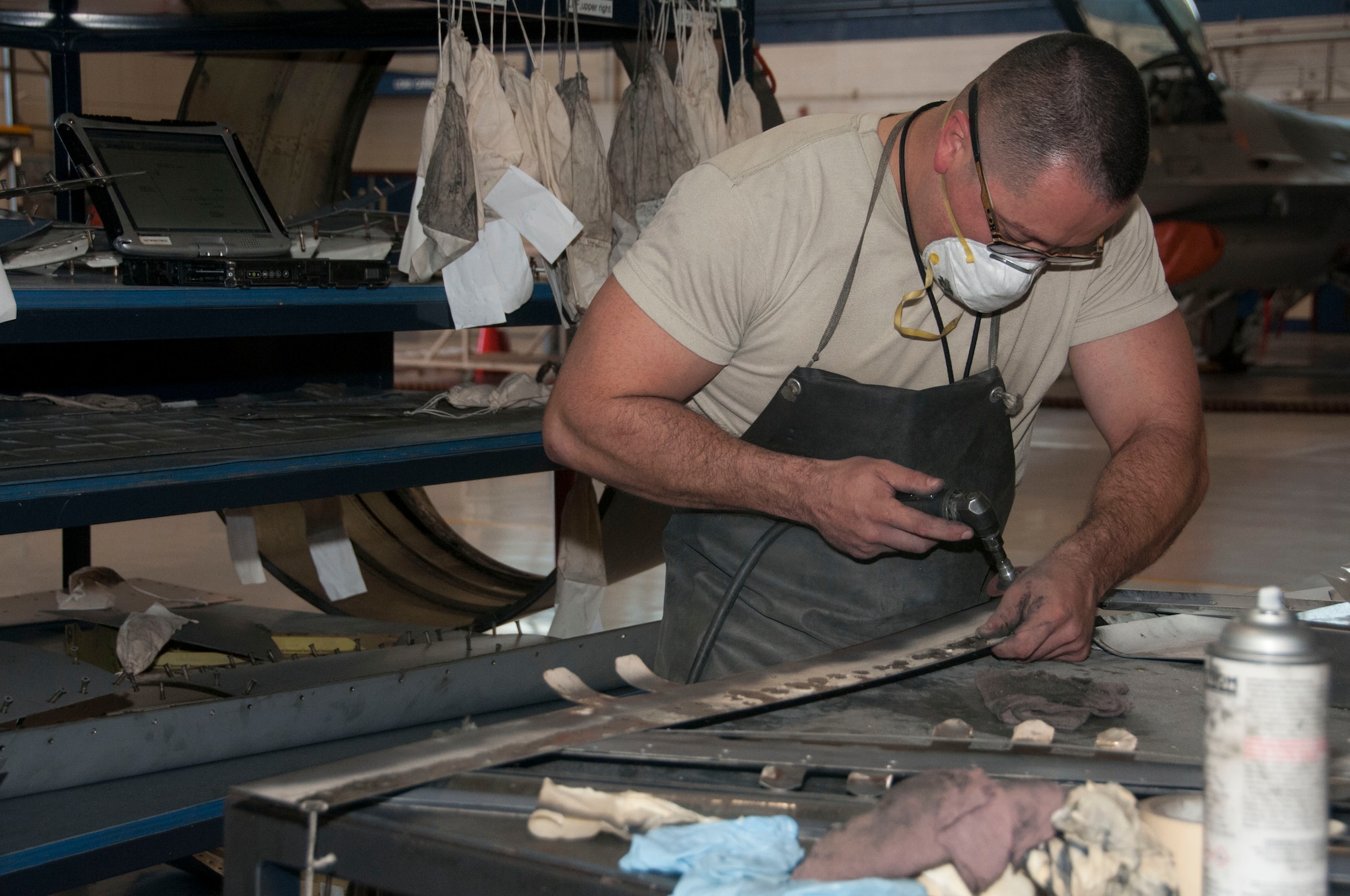 Senior Airman Solano Leon, 162nd Wing Maintenance Group, blends the leading edge flap panels for an F-16. This process ensures the surfaces are smooth to expand the life of the panels. (Air National Guard photo by Airman Mae Olson/Released)