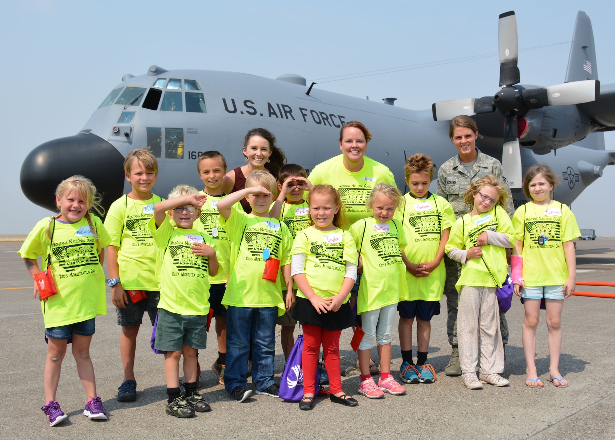 A group of children whose parents are members of the Montana National Guard pose in front of a C-130 Hercules transport aircraft following a tour of the aircraft. The children were participating in the Kids Mobility Day at the 120th Airlift Wing in Great Falls, Mont., Aug. 20, 2015. (U.S. Air National Guard photo/Senior Master Sgt. Eric Peterson)