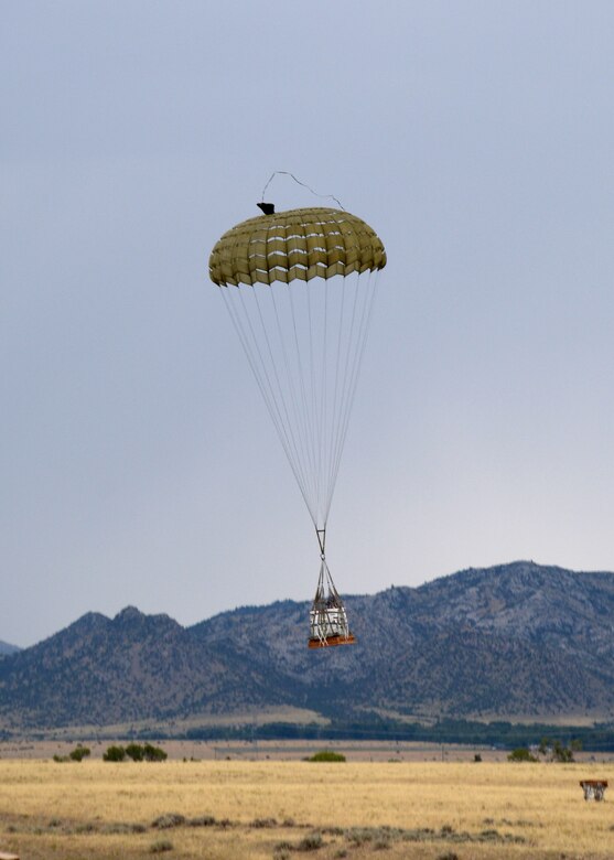 Parachuted training cargo falls to the ground after being dropped from a C-130 Hercules transport aircraft assigned to the 120th Airlift Wing of the Montana Air National Guard Aug. 12, 2015. The aircraft was taking part in an exercise dropping cargo at the Spearhead Drop Zone located west of Toston, Mont. (U.S. Air National Guard photo/Senior Master Sgt. Eric Peterson)


