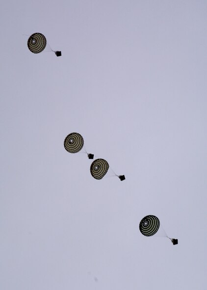 Parachuted training cargo falls to the ground after being dropped from a C-130 Hercules transport aircraft assigned to the 120th Airlift Wing of the Montana Air National Guard Aug. 12, 2015. The aircraft was taking part in an exercise dropping cargo at the Spearhead Drop Zone located west of Toston, Mont. (U.S. Air National Guard photo/Senior Master Sgt. Eric Peterson)

