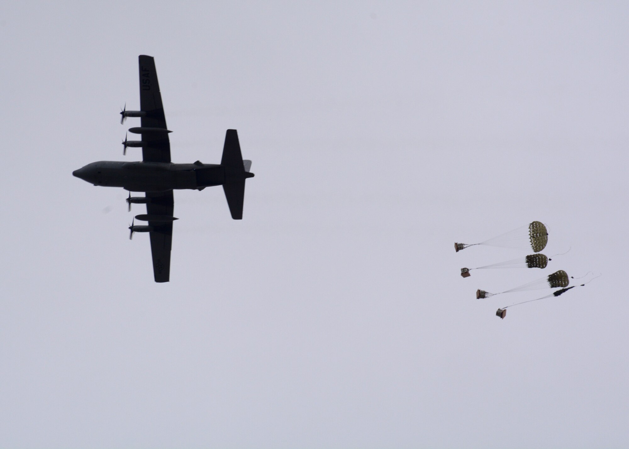 Parachuted training cargo falls to the ground after being dropped from a C-130 Hercules transport aircraft assigned to the 120th Airlift Wing of the Montana Air National Guard Aug. 12, 2015. The aircraft was taking part in an exercise dropping cargo at the Spearhead Drop Zone located west of Toston, Mont. (U.S. Air National Guard photo/Senior Master Sgt. Eric Peterson)

