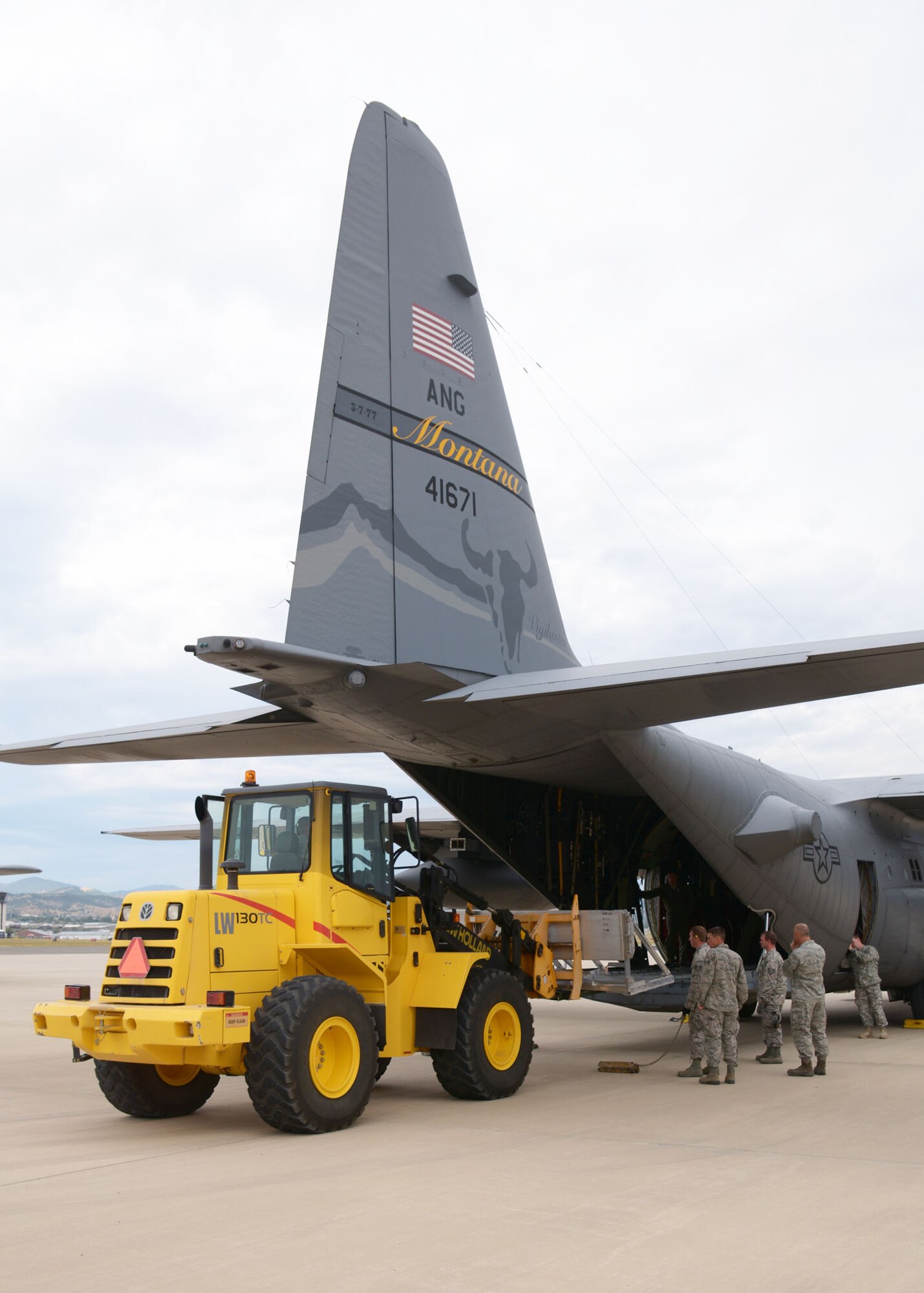 A Montana Air National Guard C-130 Hercules transport aircraft is loaded with training cargo in Helena, Mont., Aug. 12, 2015. The aircraft and crew would later fly to the Spearhead training area located west of Toston, Mont., to parachute the cargo at a designated drop zone. (U.S. Air National Guard photo/Senior Master Sgt. Eric Peterson)

