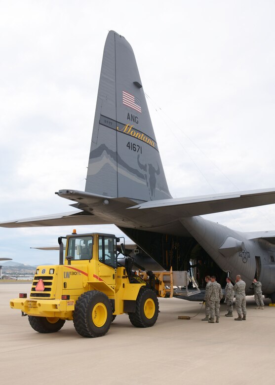A Montana Air National Guard C-130 Hercules transport aircraft is loaded with training cargo in Helena, Mont., Aug. 12, 2015. The aircraft and crew would later fly to the Spearhead training area located west of Toston, Mont., to parachute the cargo at a designated drop zone. (U.S. Air National Guard photo/Senior Master Sgt. Eric Peterson)

