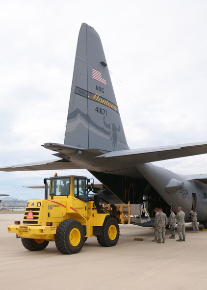 A Montana Air National Guard C-130 Hercules transport aircraft is loaded with training cargo in Helena, Mont., Aug. 12, 2015. The aircraft and crew would later fly to the Spearhead training area located west of Toston, Mont., to parachute the cargo at a designated drop zone. (U.S. Air National Guard photo/Senior Master Sgt. Eric Peterson)

