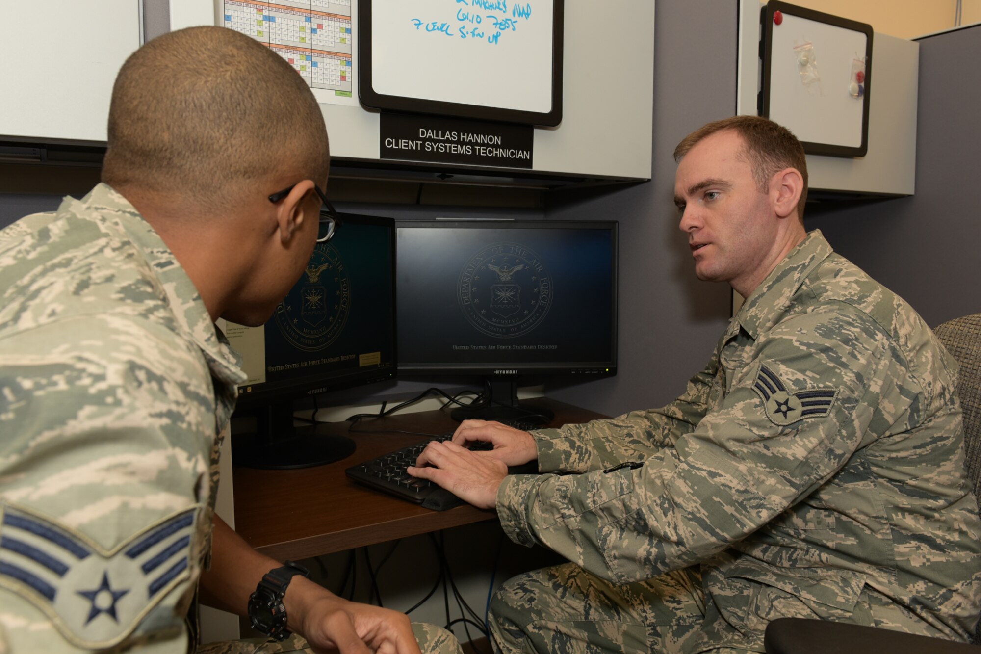 Senior Airman Dallas Hannon (right), 403rd Communications Flight client systems technician, mentors Senior Airman Treviant Evans, 403rd CF client systems technicians, on remote accessing another computer Sept. 13, 2015, at Keesler Air Force Base, Miss. Hannon particpates in Toastmasters International to help improve his public speaking, mentoring and leadership skills. (U.S. Air Force photo/Tech. Sgt. Ryan Labadens)